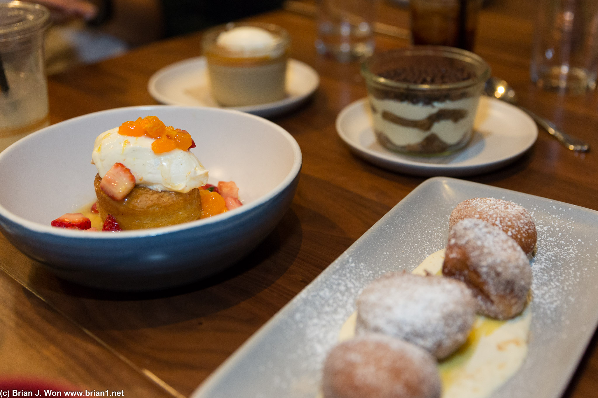 Olive oil cake and beignets in the foreground. Nom, especially the beignets!