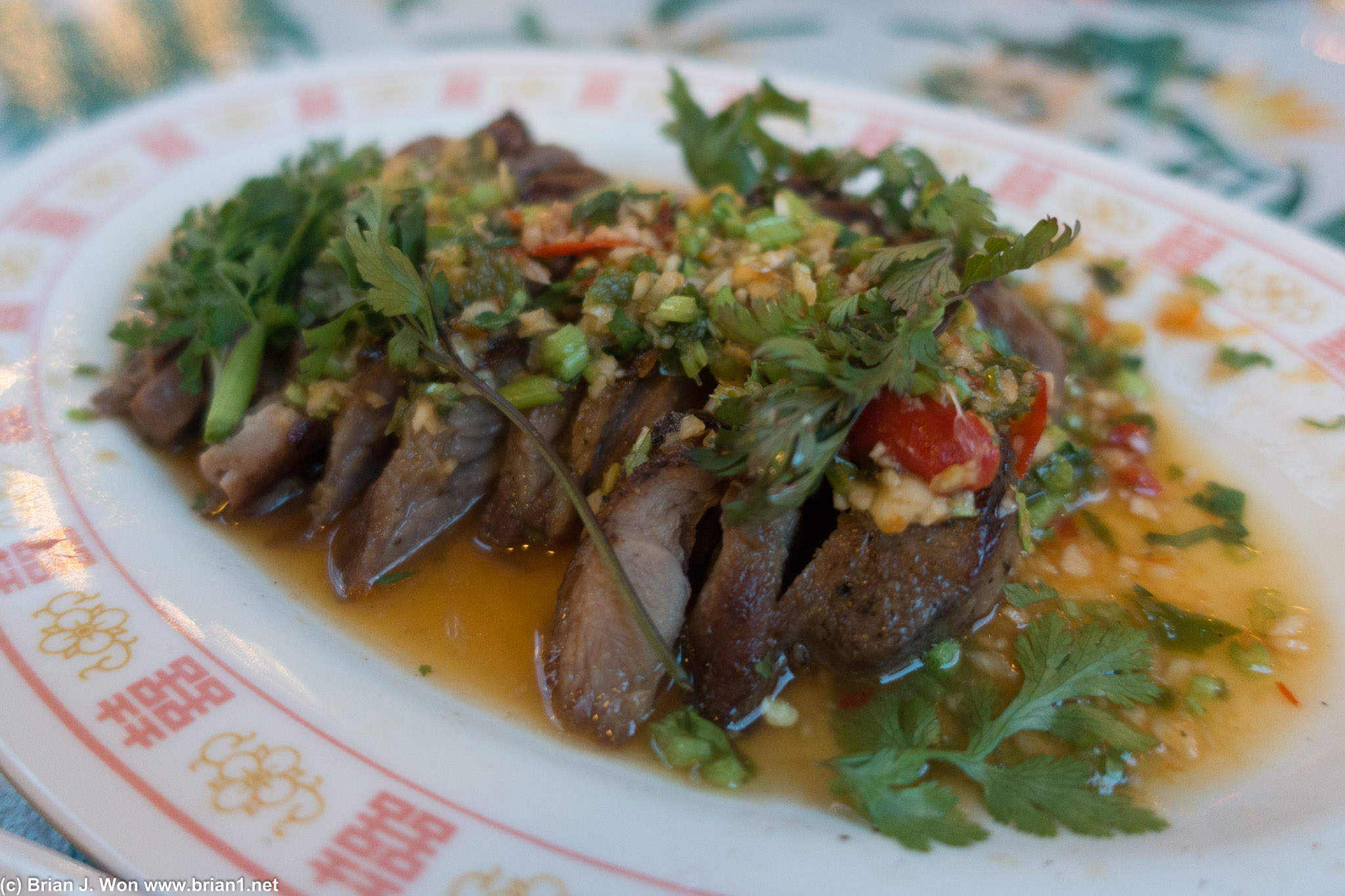 Muu Paa Kham Waan (boar collar meat, served with iced mustard greens on a separate plate).