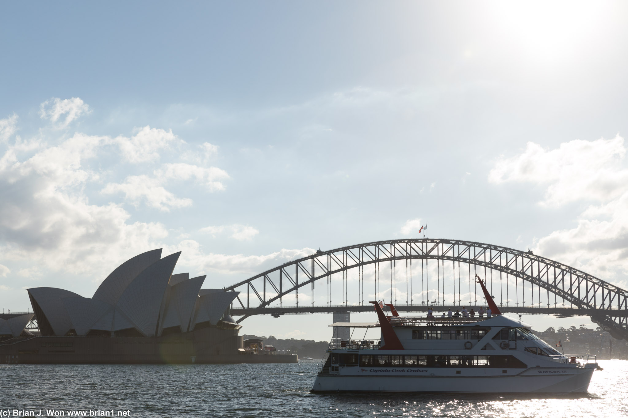 Sydney Opera House and Sydney Harbour Bridge, with a harbour cruise in the foreground.