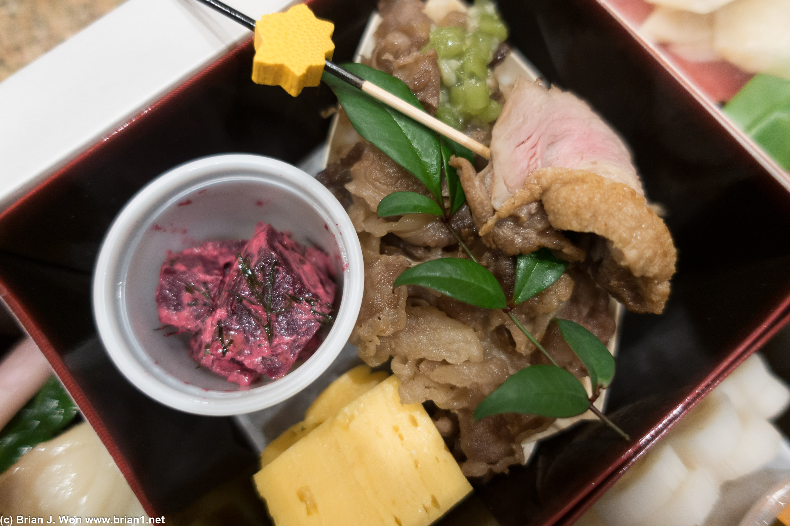 Roast duck, tamago, a tiny rice bowl with beef...