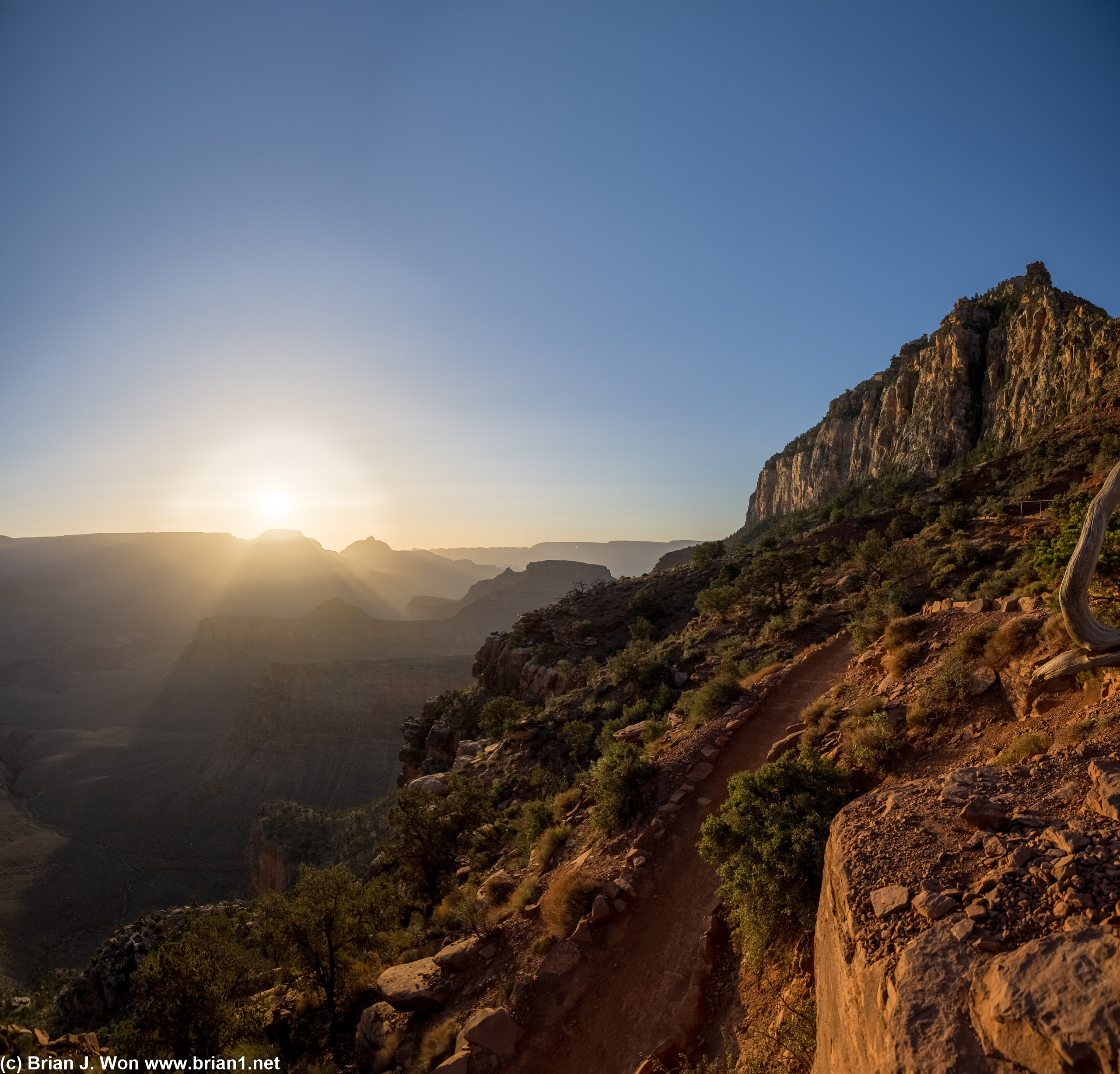 The sunrise highlights the continued descent of South Kaibab trail.