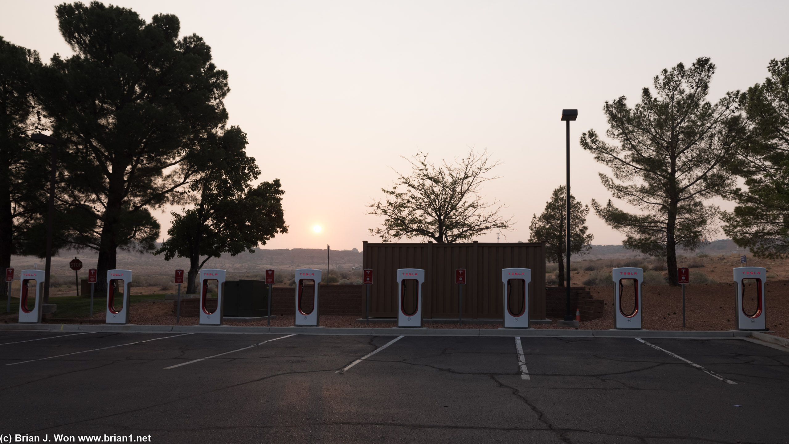 Tesla Supercharger right at the hotel. Sun is red from the smoke.