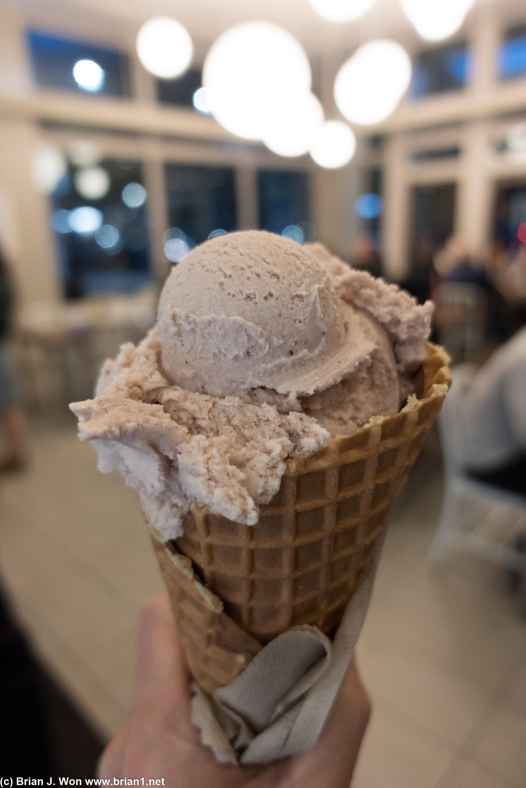 Fresh strawberry ice cream in a waffle cone.