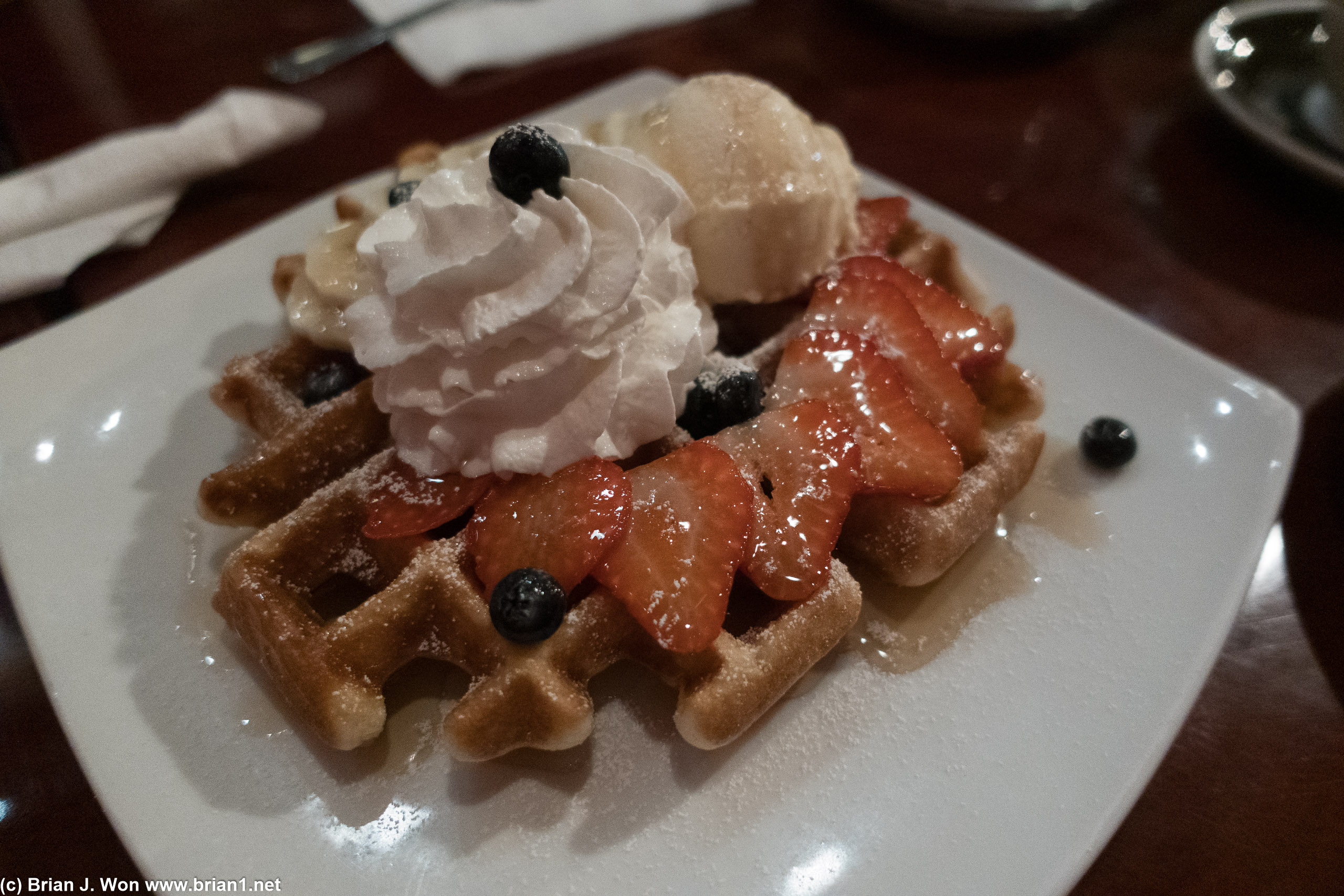 Waffle, fruit, and ice cream for dessert.