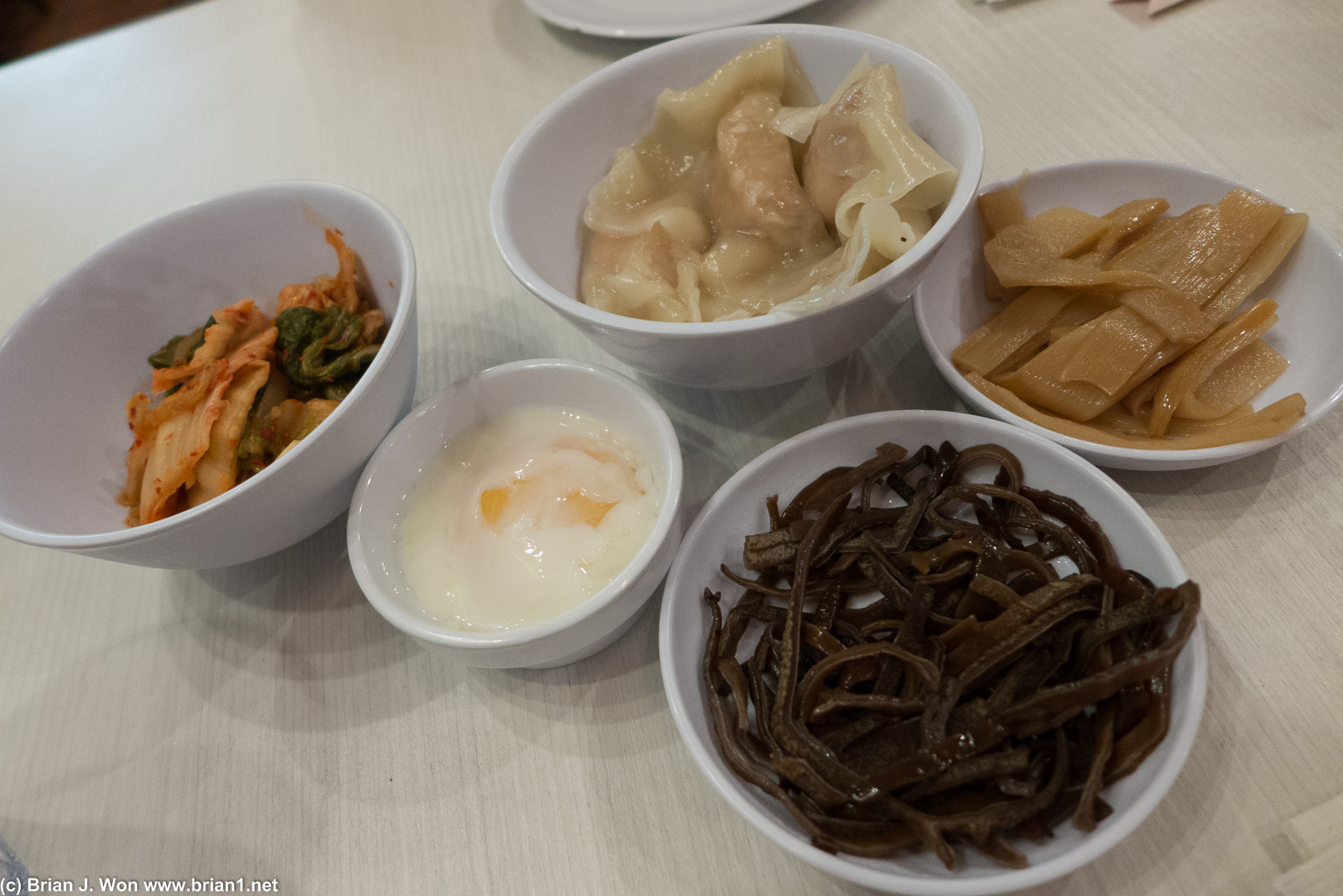 Kim chi, poached egg, shrimp won tons, pig ear mushroom, bamboo shoots.