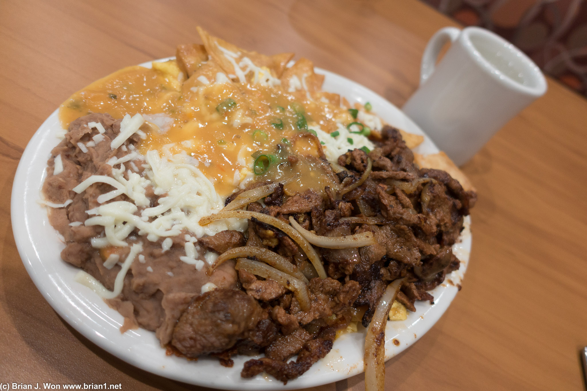 Chilaquiles complete with carne asada, beans, and egg. Definitely heavy.