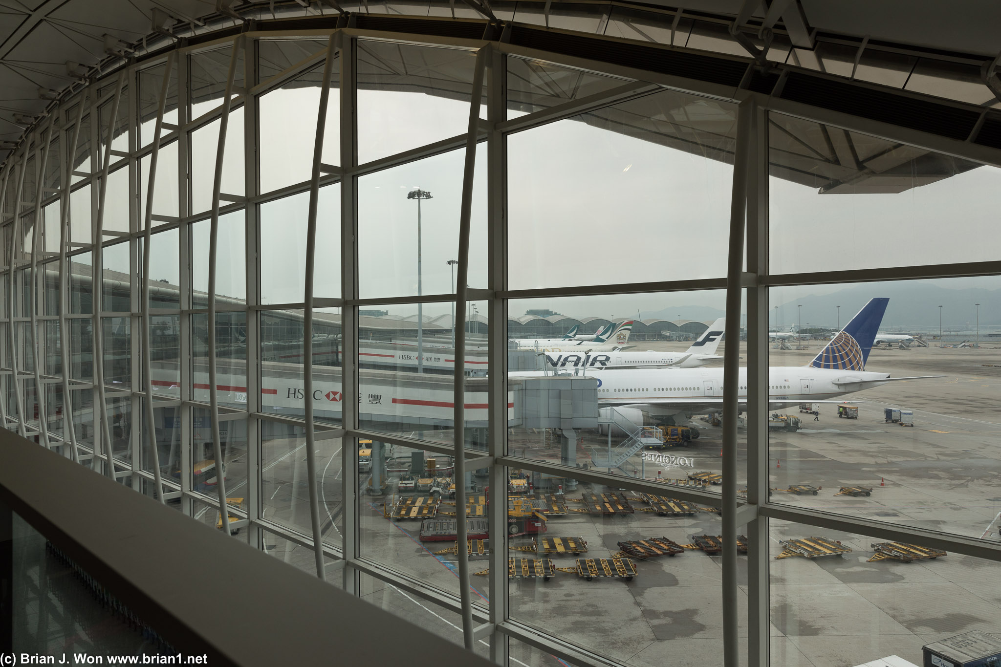 United, Finnair, Etihad, and Cathay Pacific widebodies at HKG Terminal 1.