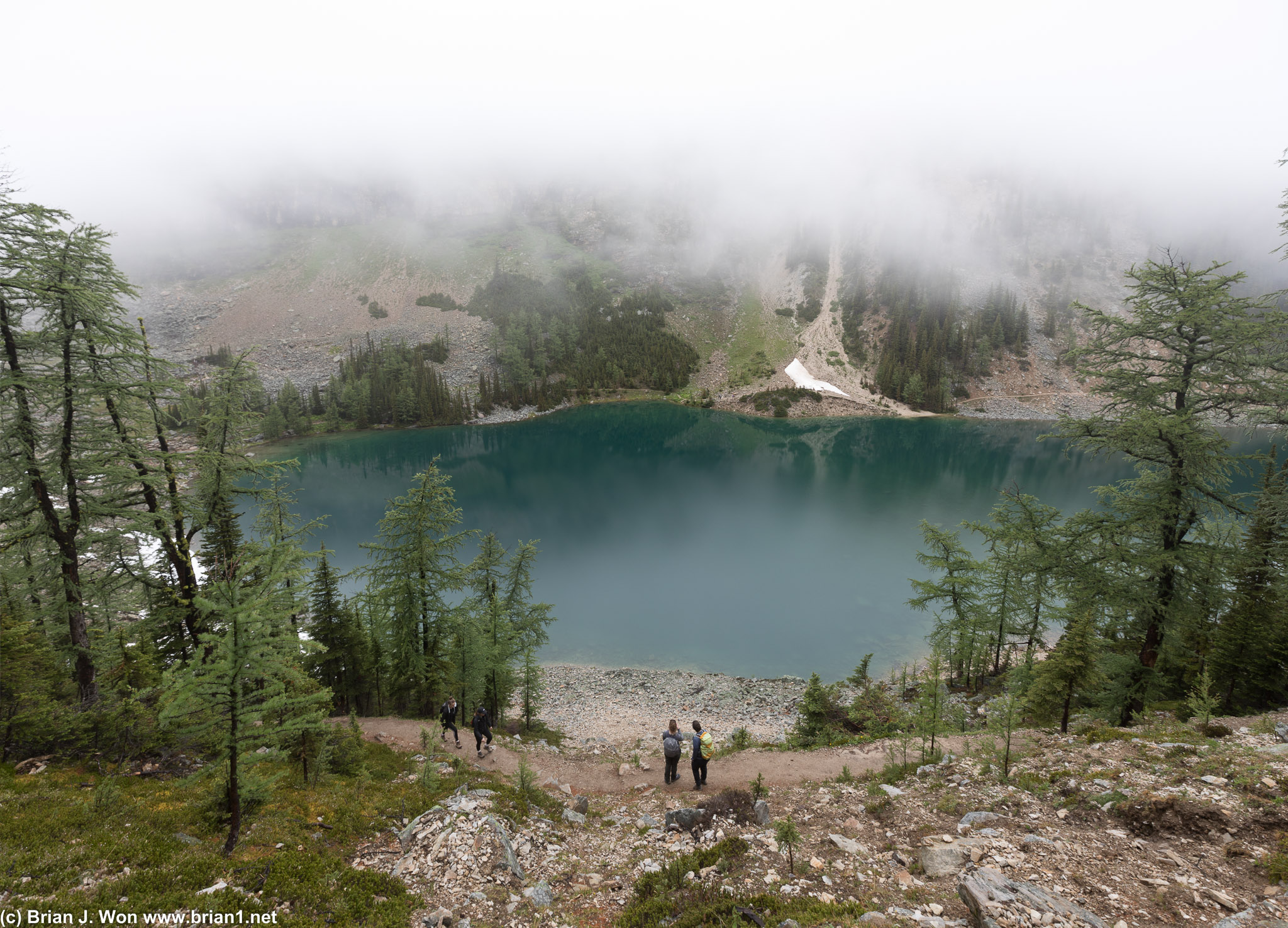 Lake Agnes reveals itself through the clouds.