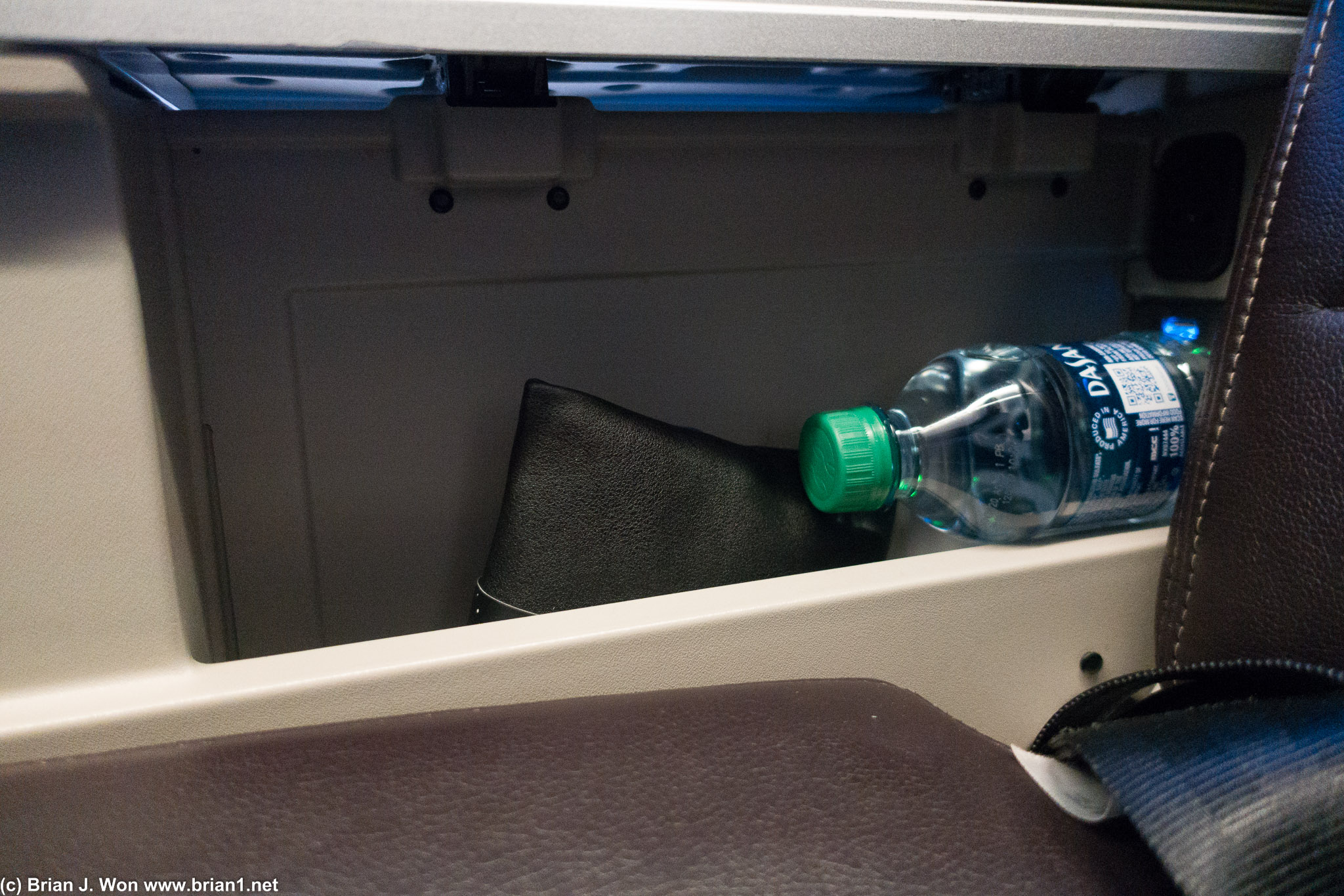 Amenity kit and little bottle of water hiding in the armrest. Charging port too.