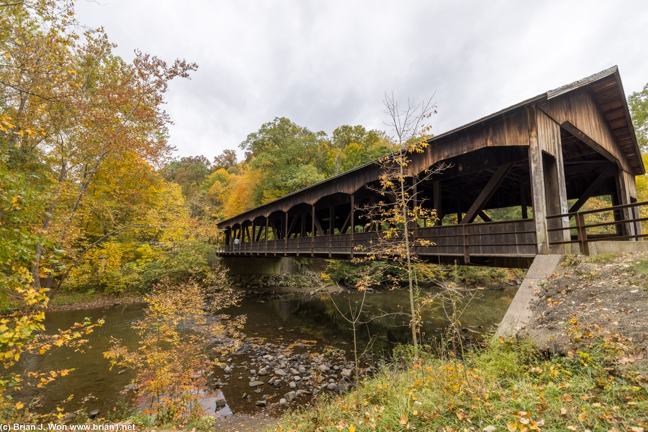 Fall colors over a covered bridge on the Clear Fork Mohican River.