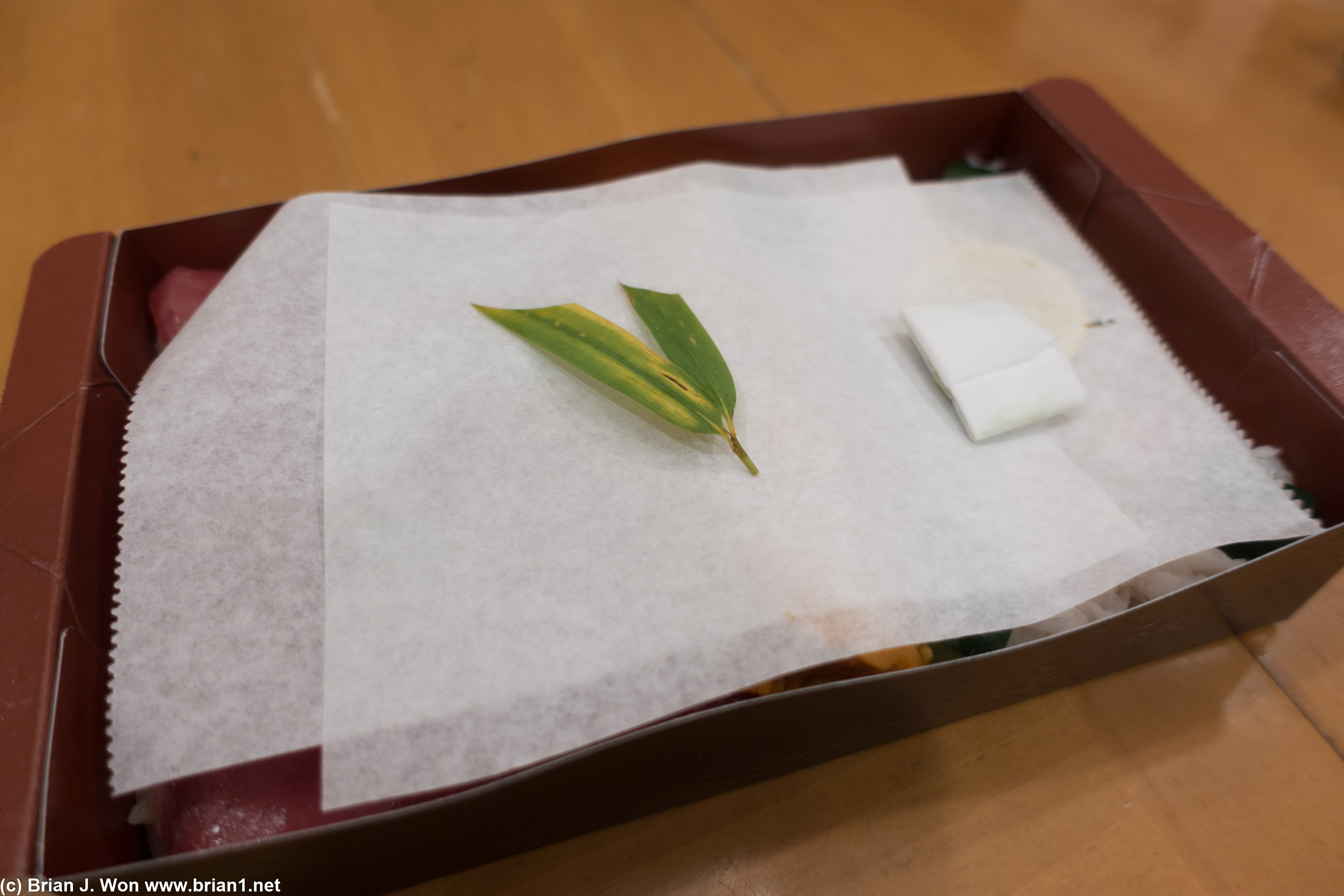 What lies underneath the wax paper and decorative leaf?