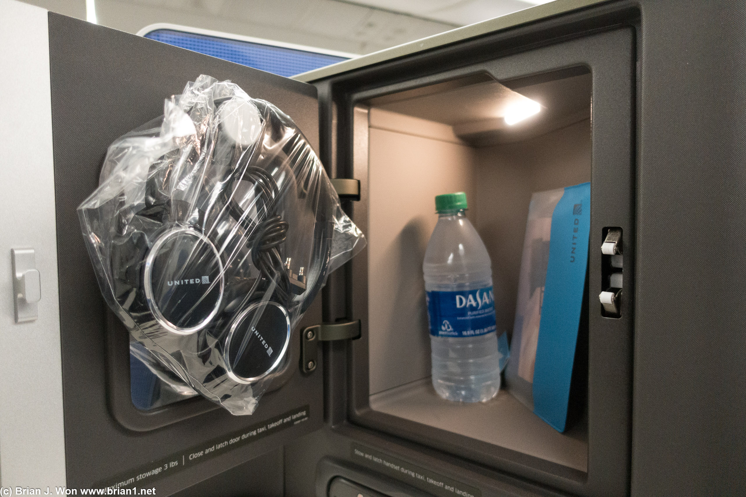 Oooo, bottled water already at your seat? Amenity kit and bottled water already placed thoughtfully in the storage cubby, too.