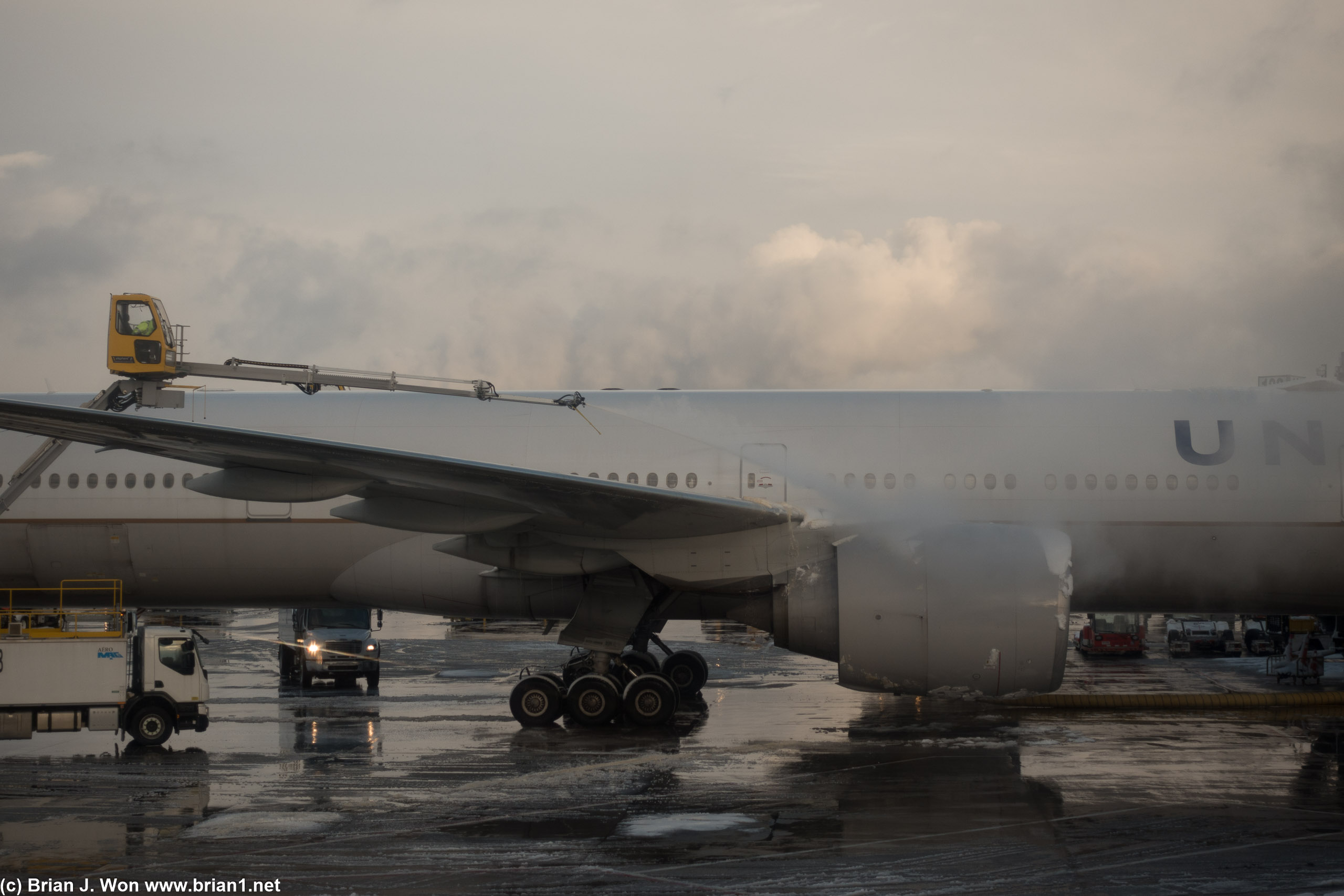 A big 777-300ER being de-iced at the gate.