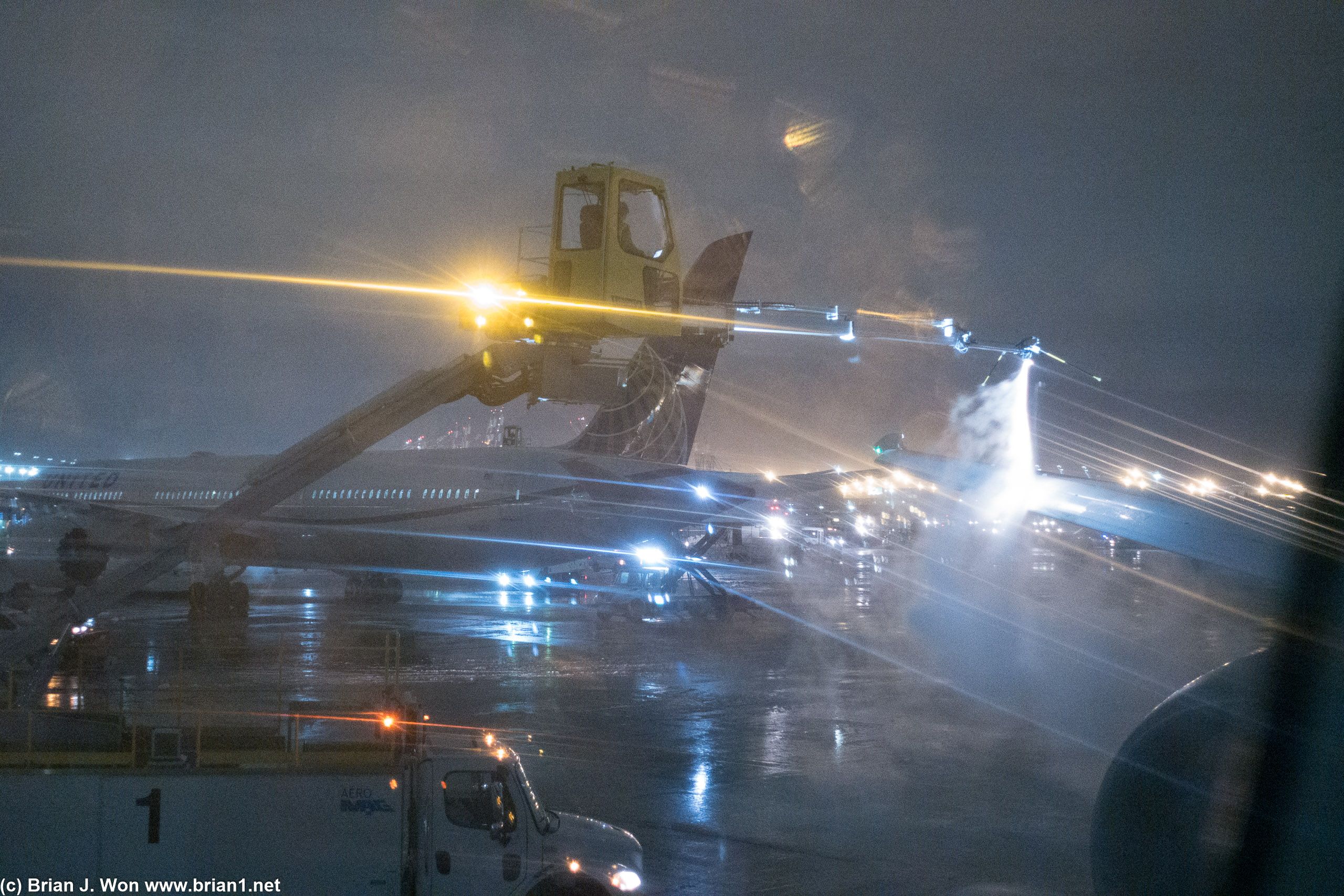 Another Boeing 787 Dreamliner in the background, also being de-iced.