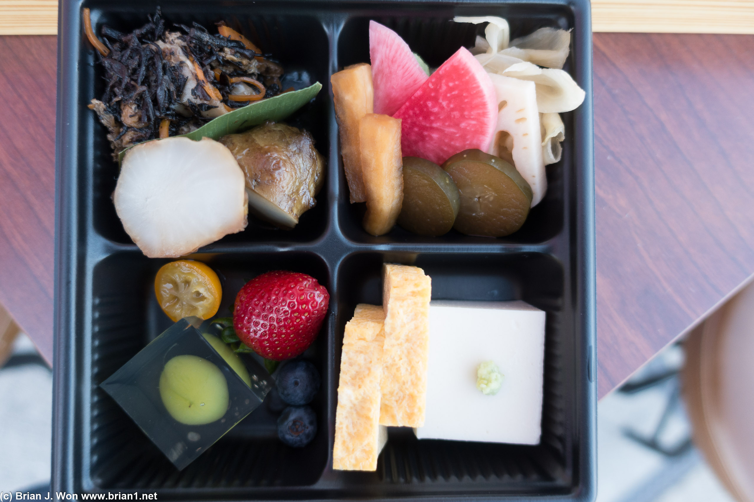 Appetizer box: oshinko (pickled veggies), tofu, tamago, kabocha (squash), hijiki (seaweed), yamamomo (peach agar), strawberry, blueberry, kumquat.
