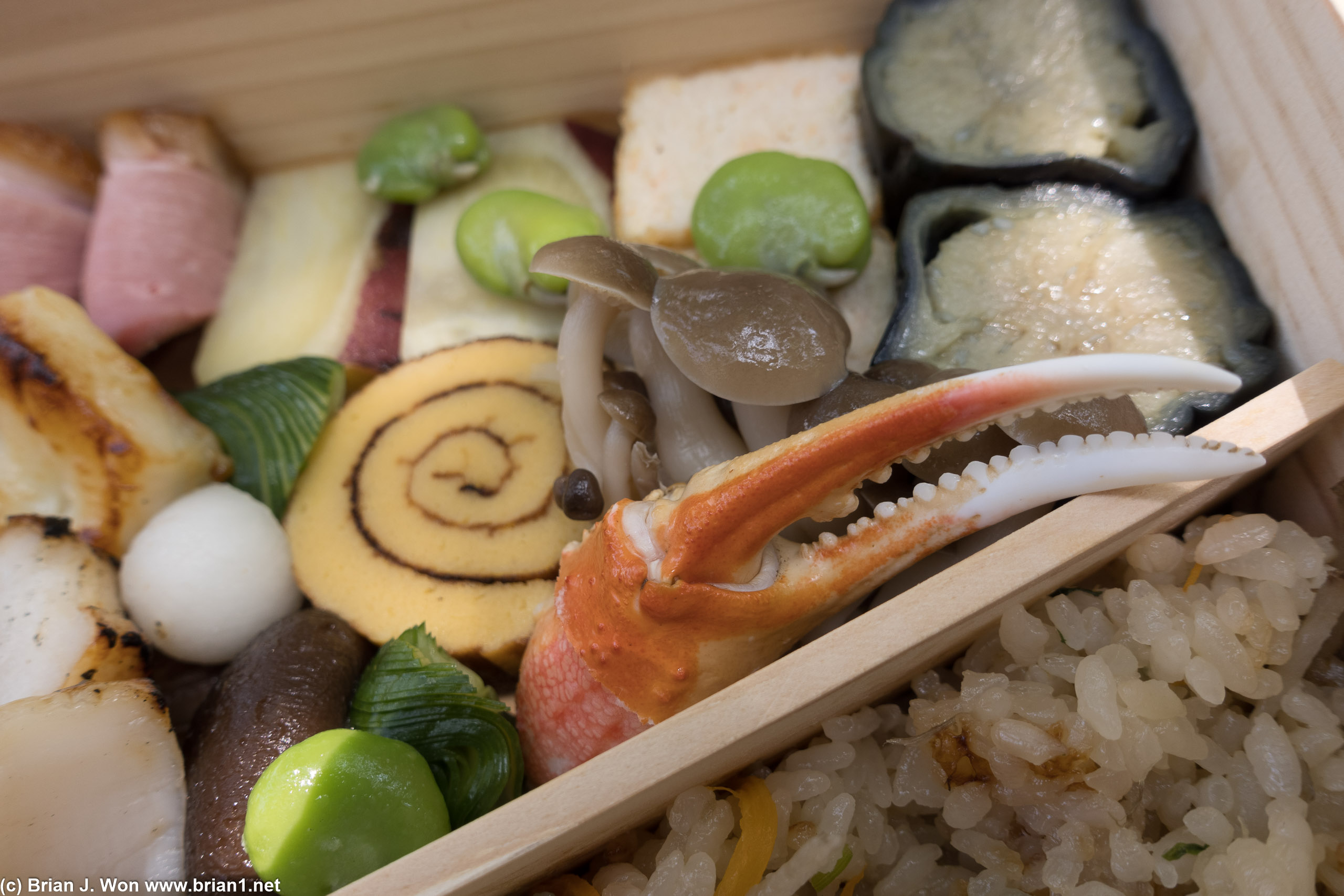 Crab claw, honshimeji mushroom ohitashi, and tamago dominate the center, with agedashi eggplant at top right.