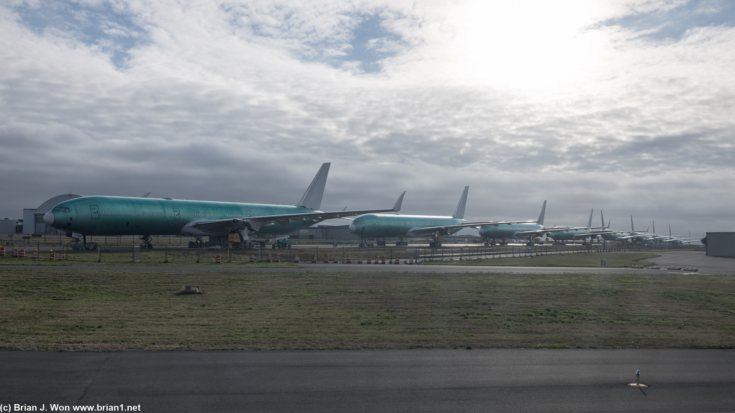 All 7 777X airframes viewed from the taxiway.