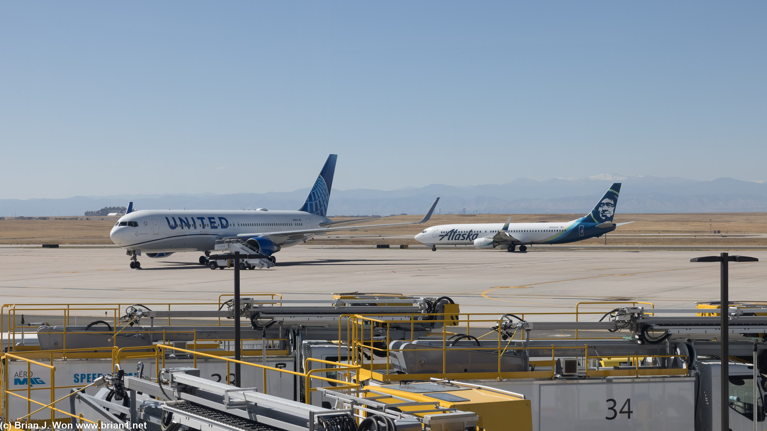 United 767-300ER next to an Alaska 737-900ER.