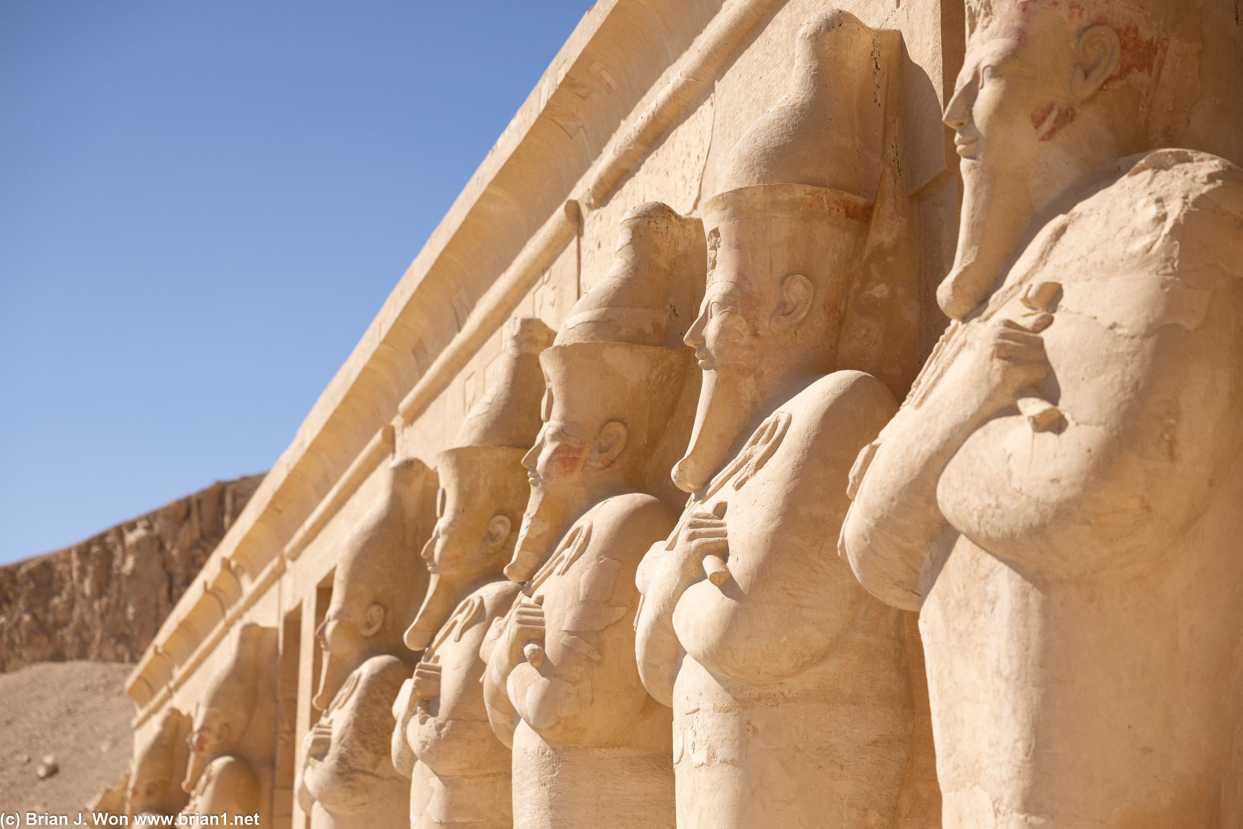 Statues of Queen Hatshepsut line the upper terrace.