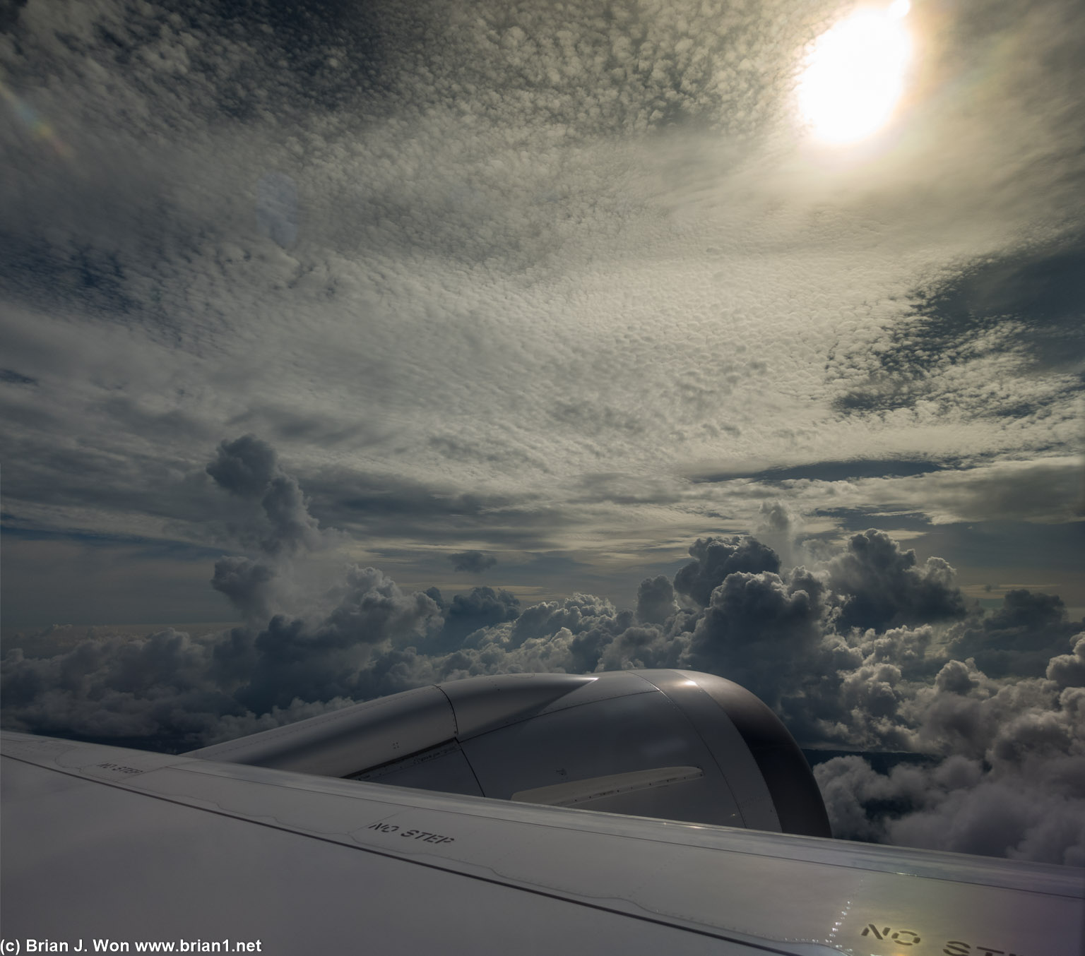 Towering clouds, yet the plane is climbing even higher.