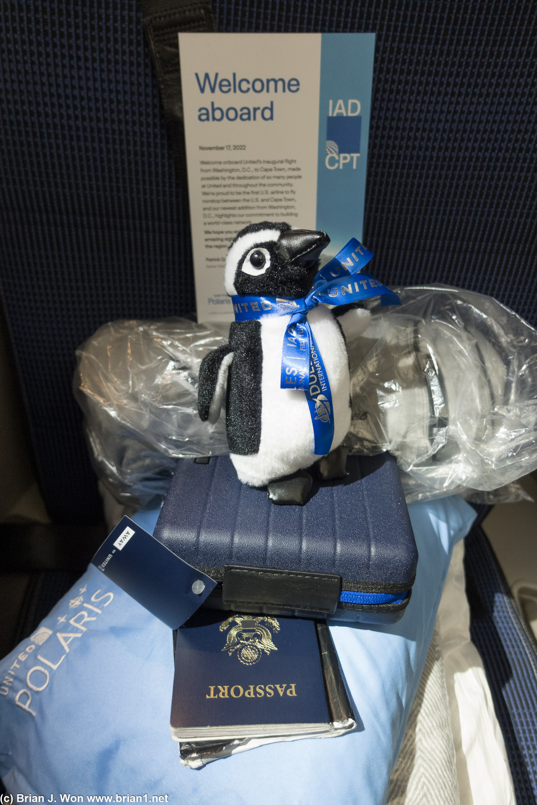 Inaugural flight penguin atop the standard Away amenity kit.