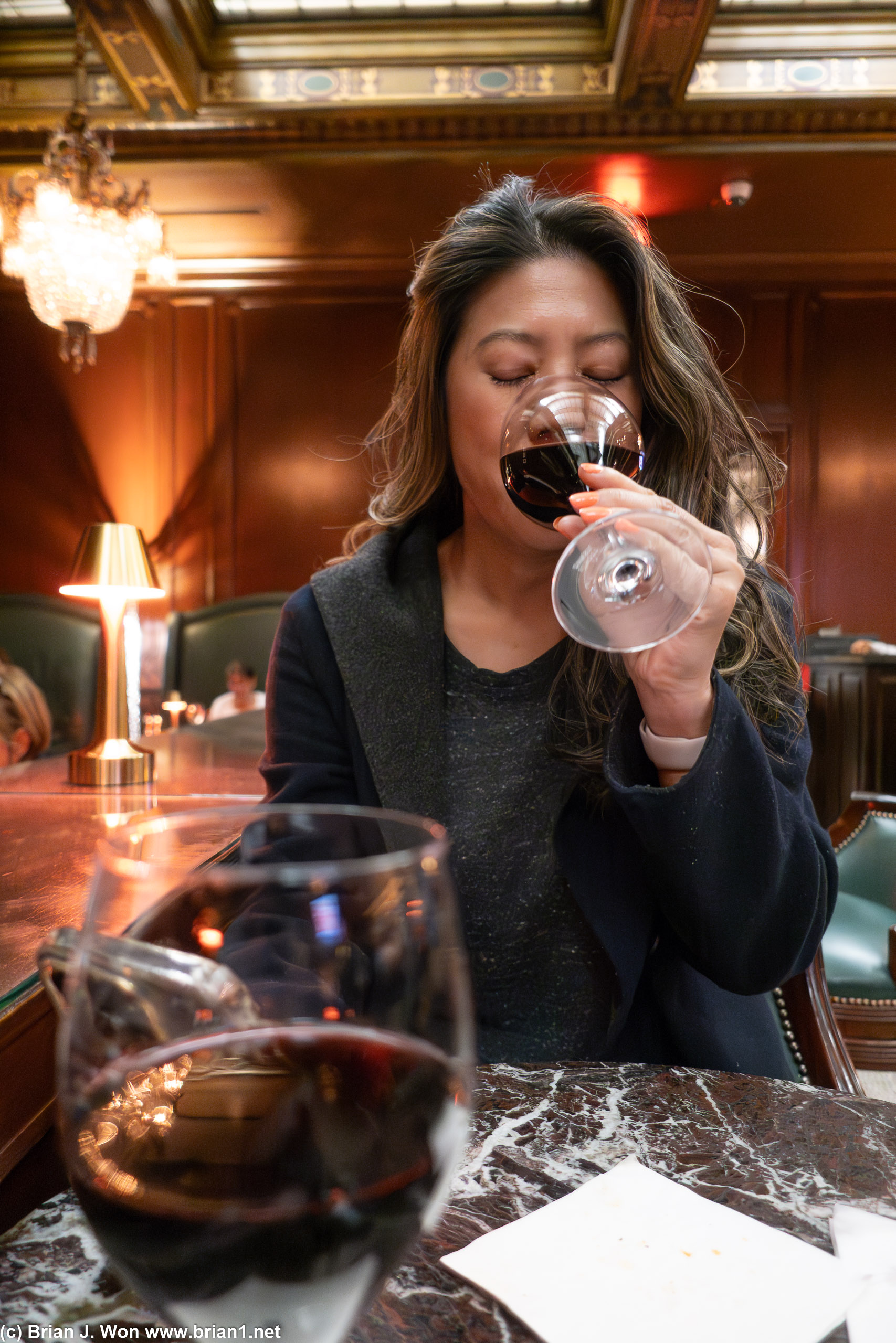 Enjoying her wine.