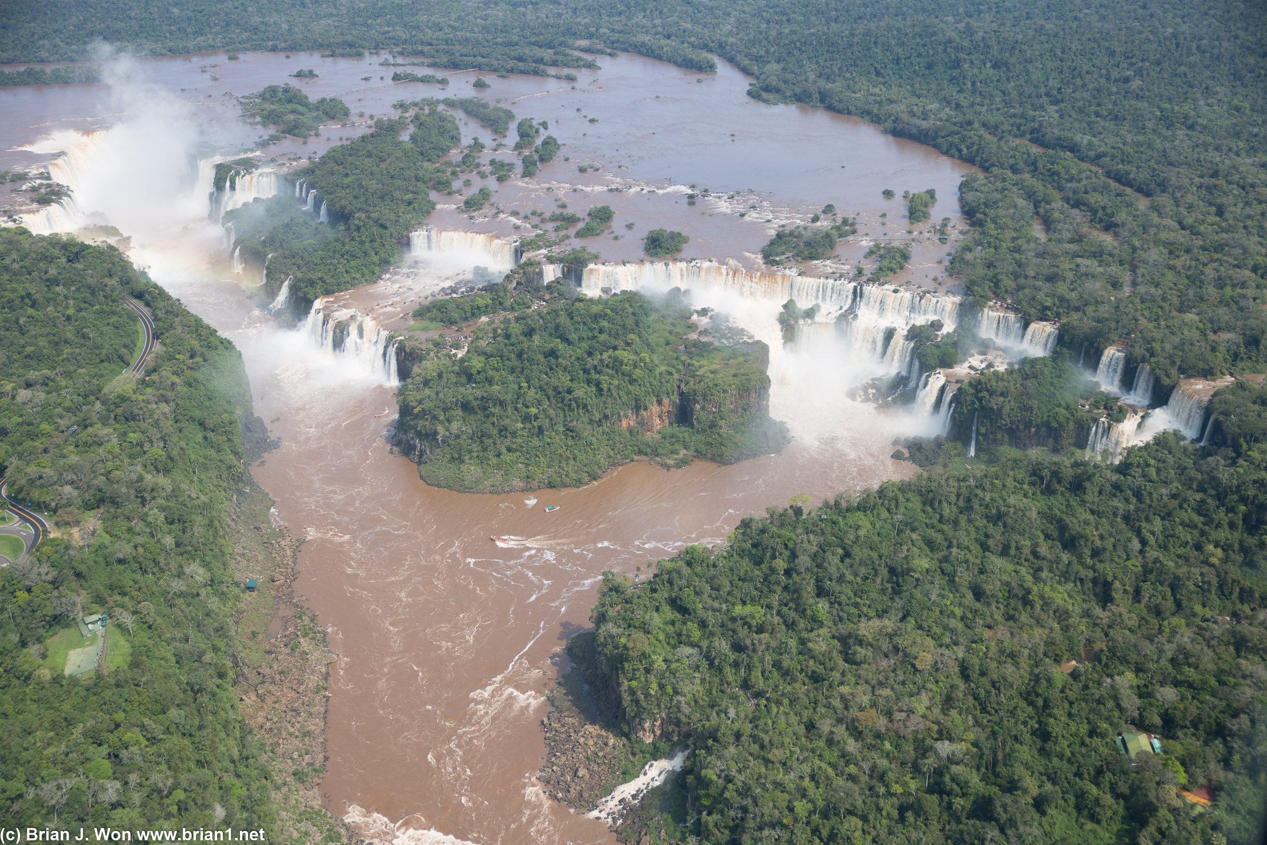Rainbows, mist, and Iguazu Falls, with San Martin Island prominently in the middle of the falls.