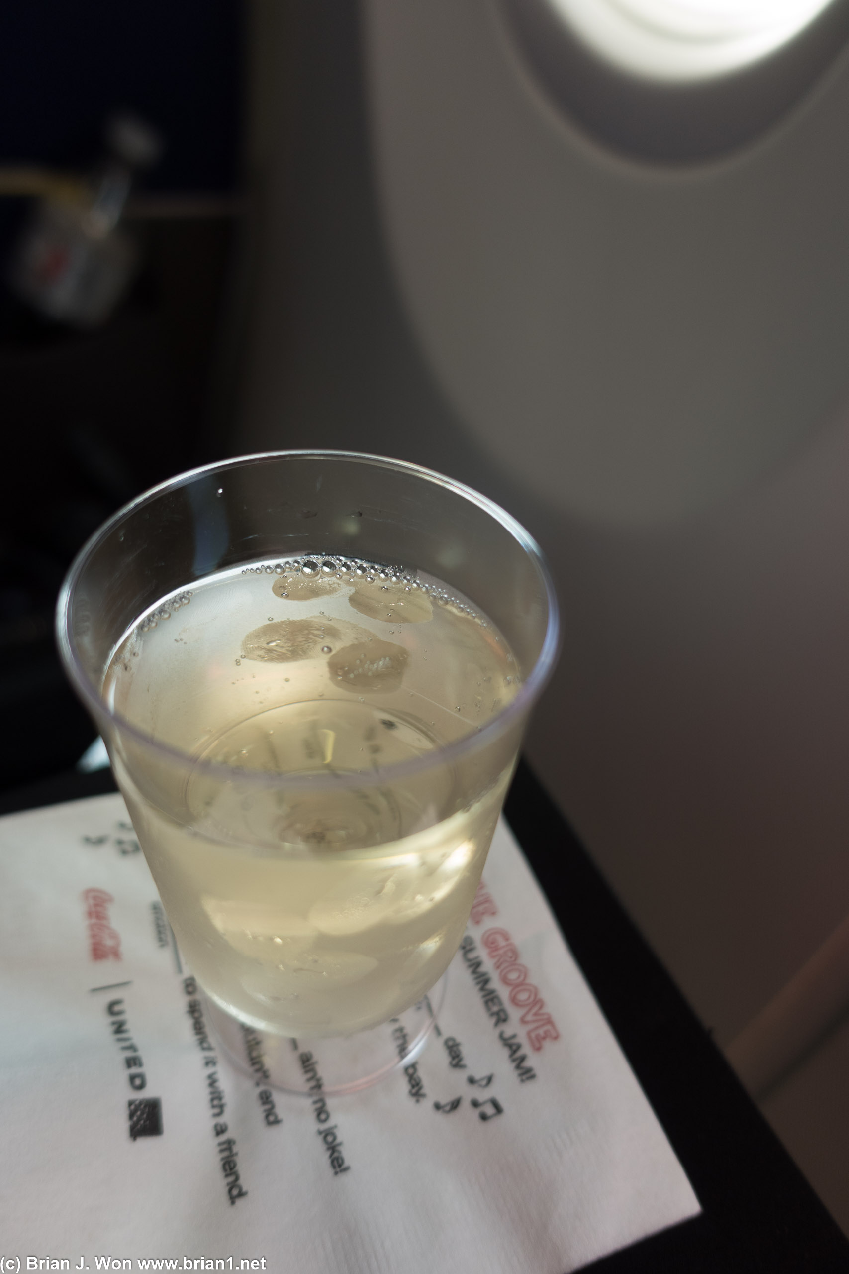 Flight crew hooked me up with a glass of sparkling wine from the first class cabin.