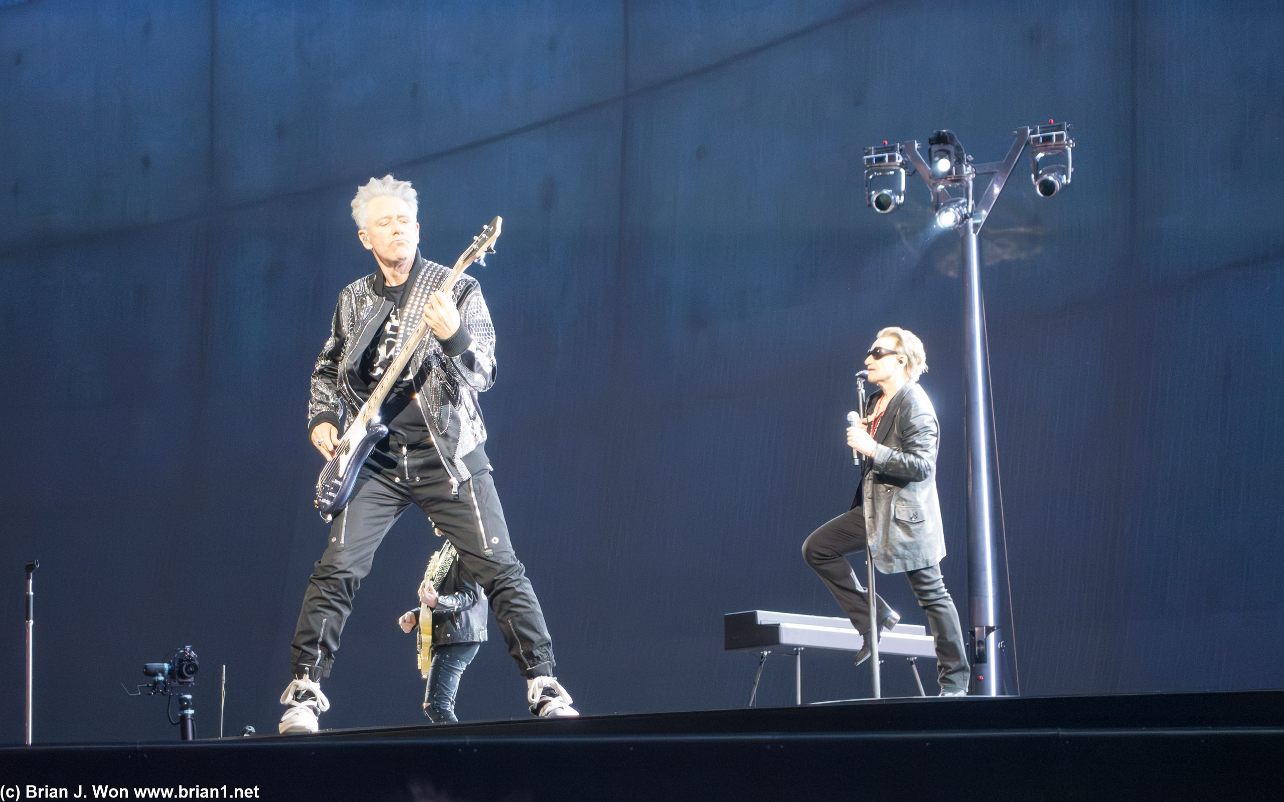 Adam on guitar, Bono in the background.