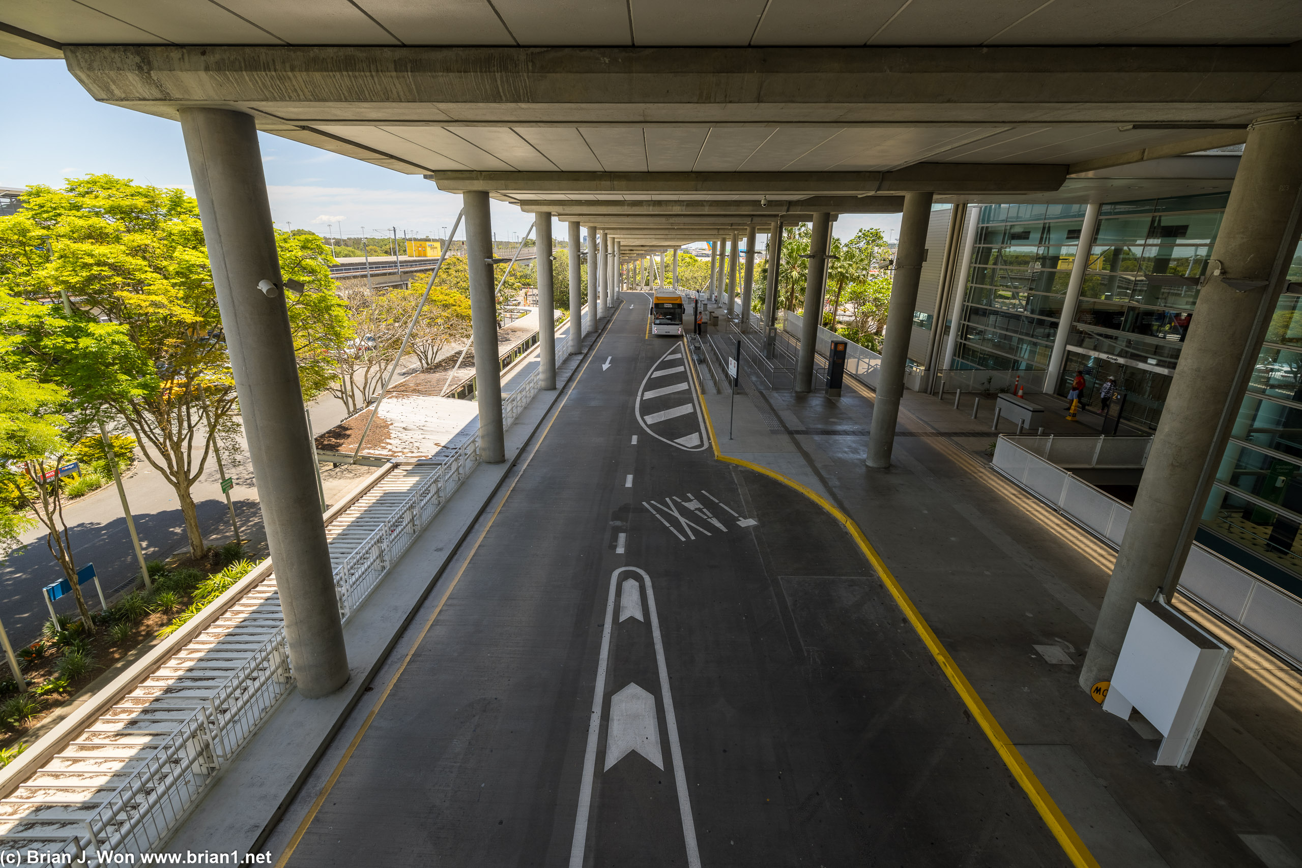 Massive elevated roadway, arrivals below at ground level, departures above.