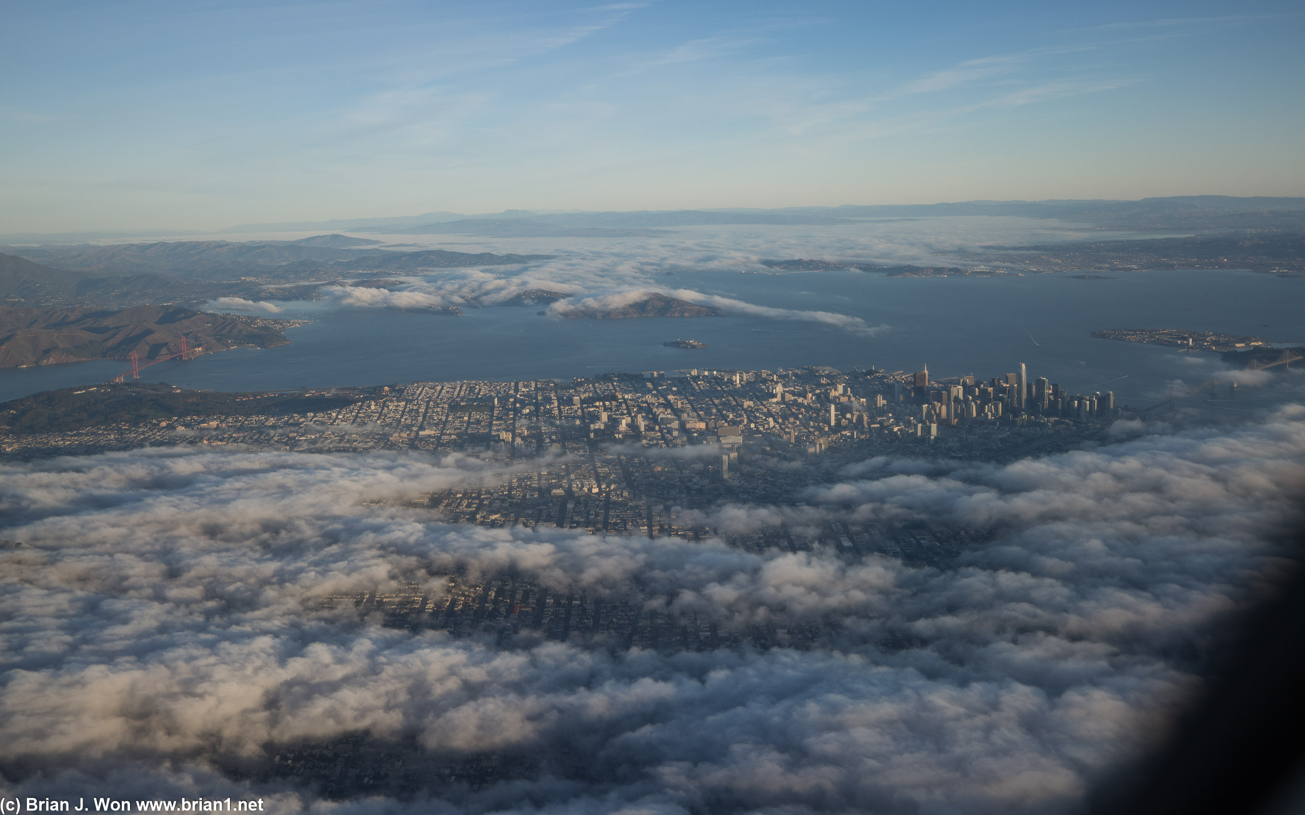 The San Francisco skyline  beginning to assert itself over the morning fog.