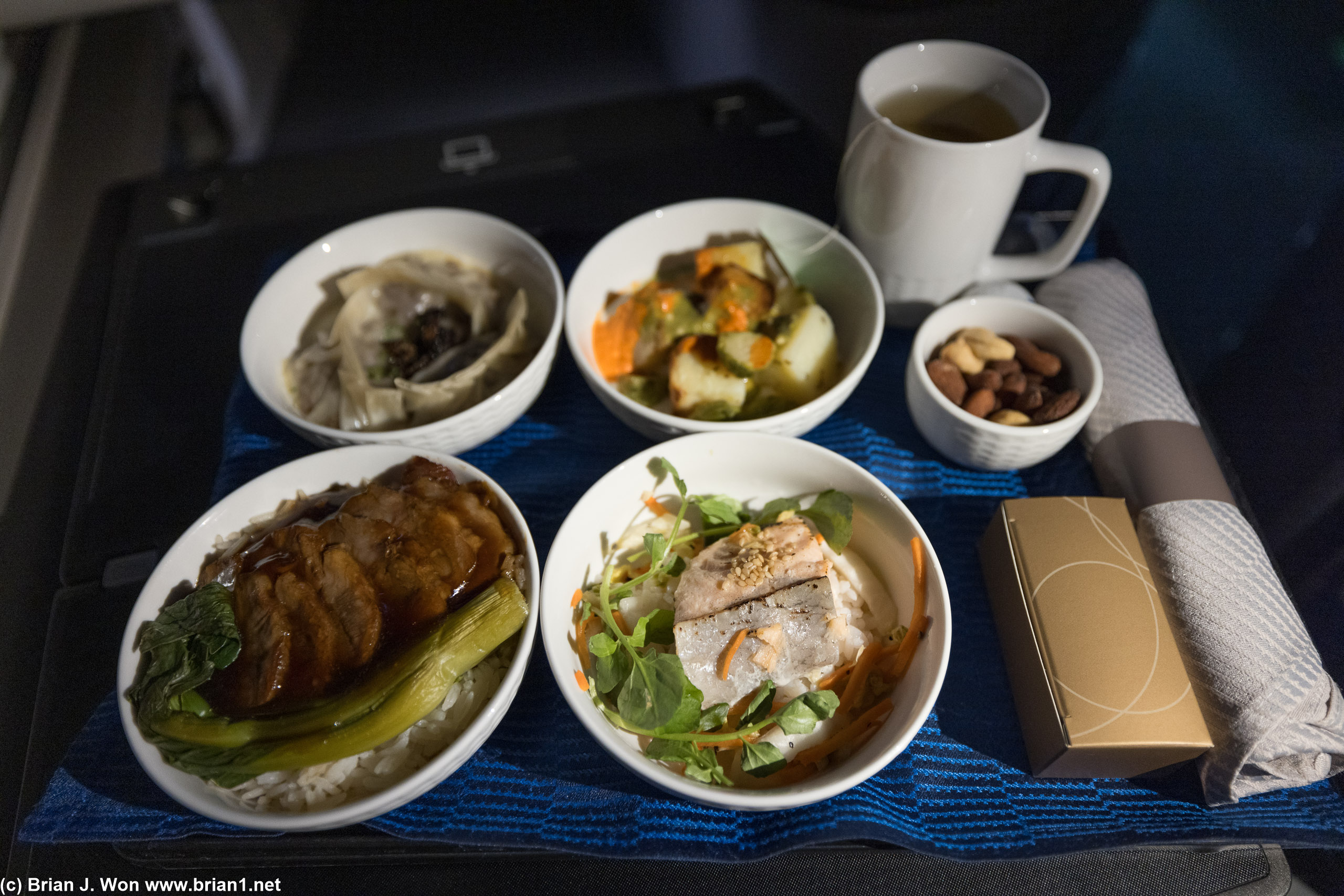Mid-flight tapas is not bad, but felt like more food than dinner, especially with the pork and rice dish at bottom left.