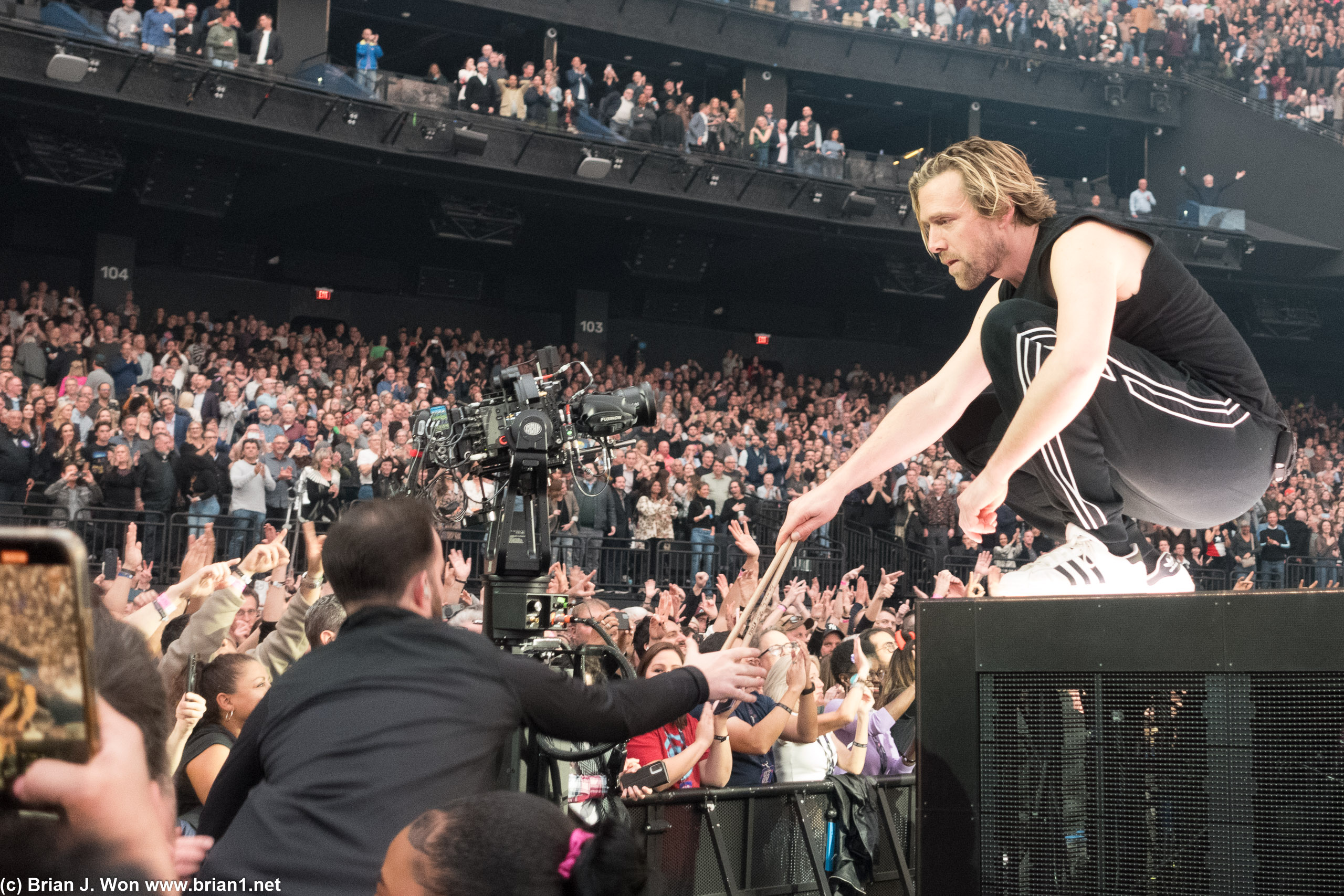 Braum giving his drum sticks to a lucky fan.