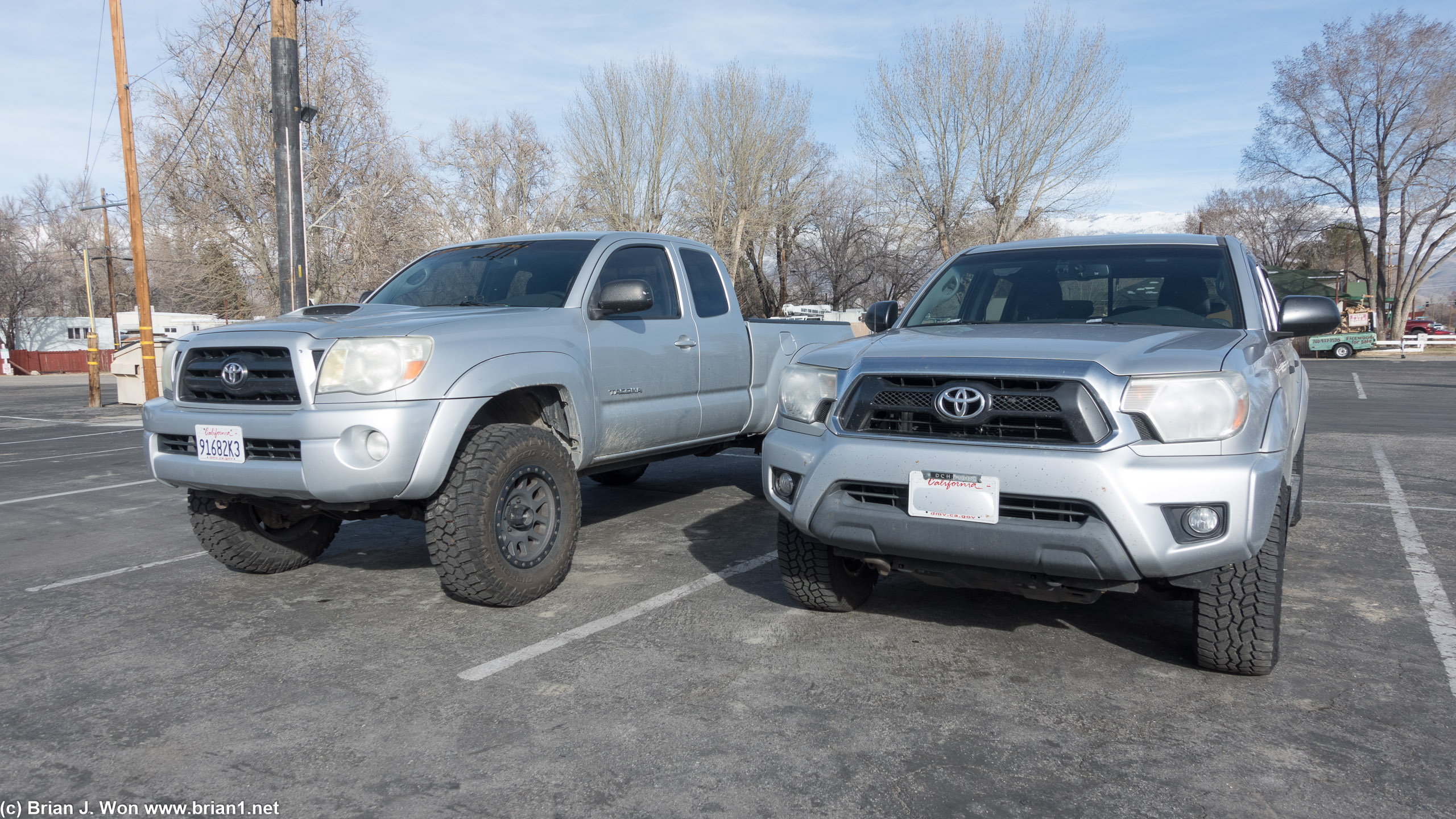 2nd gen Tacomas, lifted (maybe a 2009 TRD Sport?) on left, stock (2012?) on right.