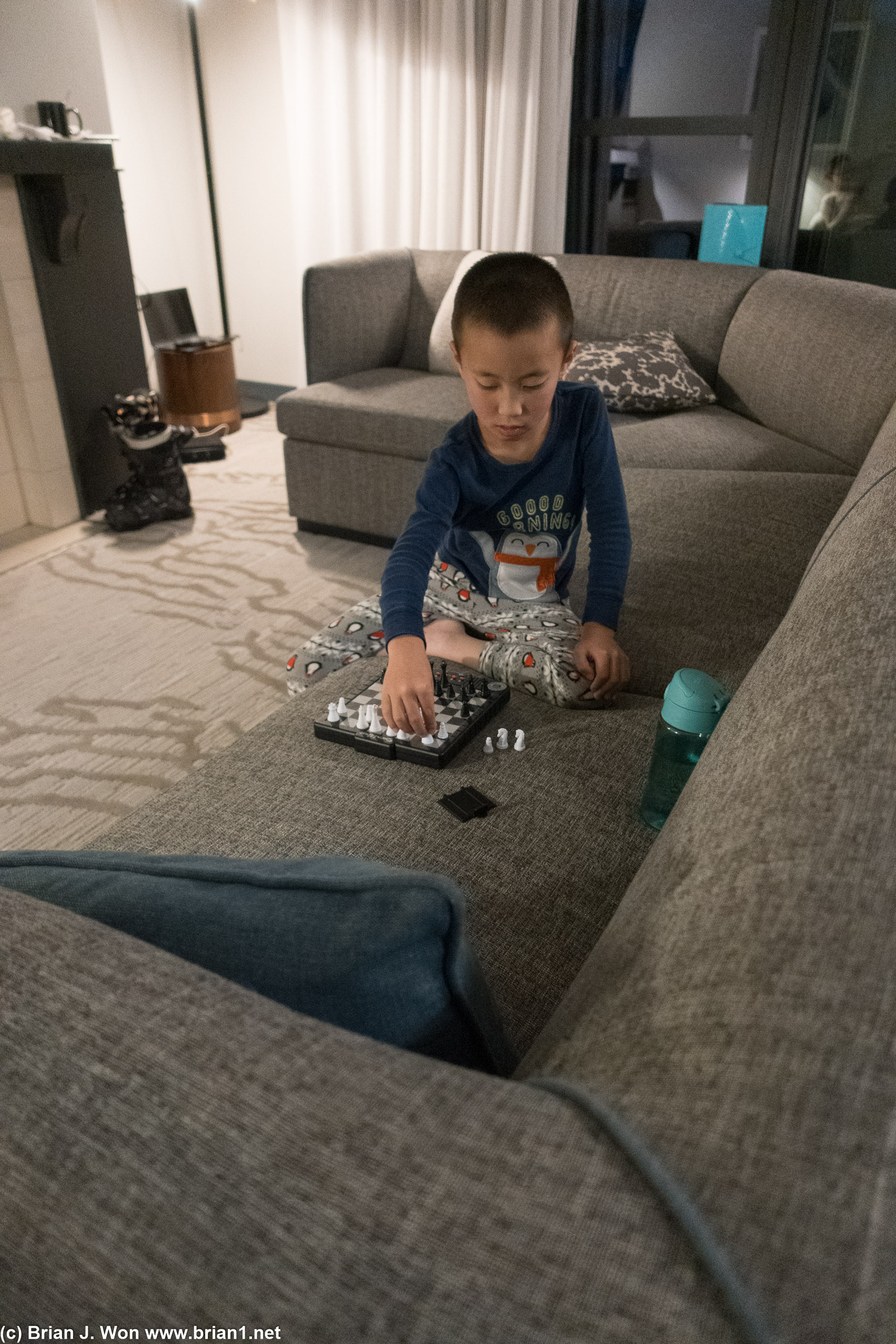 Unsure if Lucas is resetting the chess board or just making a mess.