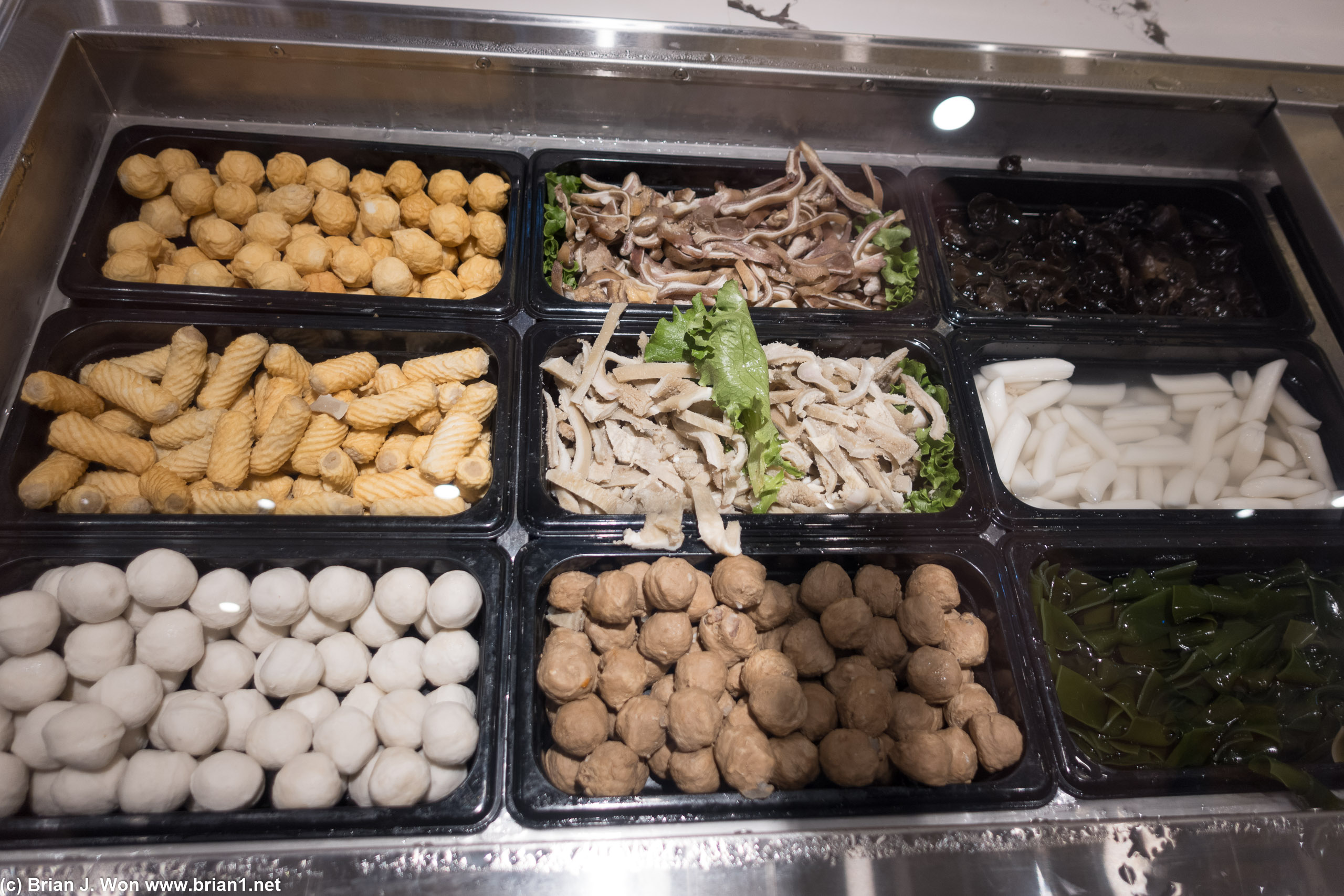 Multiple kinds of fish balls, pig ear, marinated tripe, rice cakes, seaweed knots.