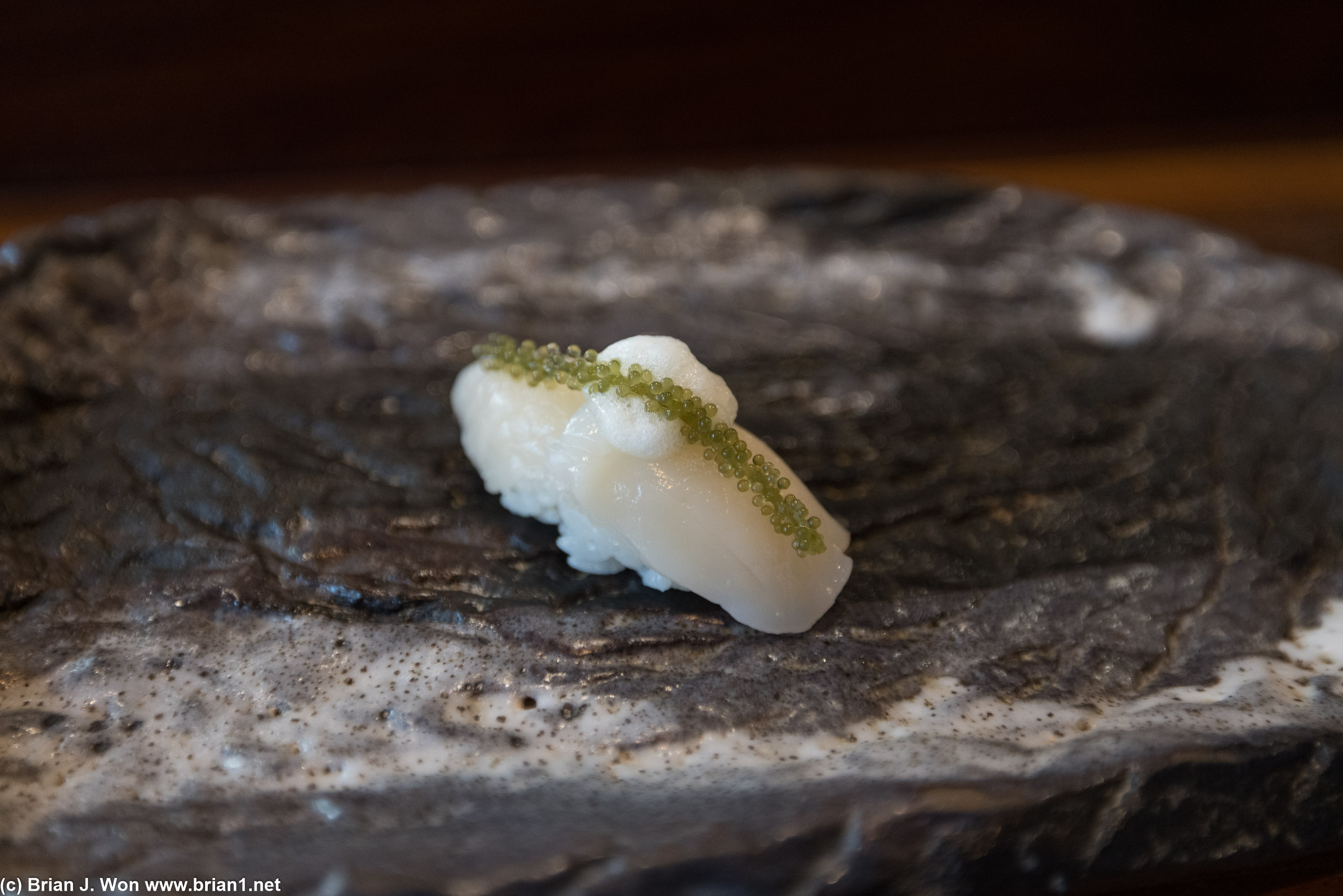 Japanese hotate with Japanese sea salt, yuzu foam, sea grapes seaweed.