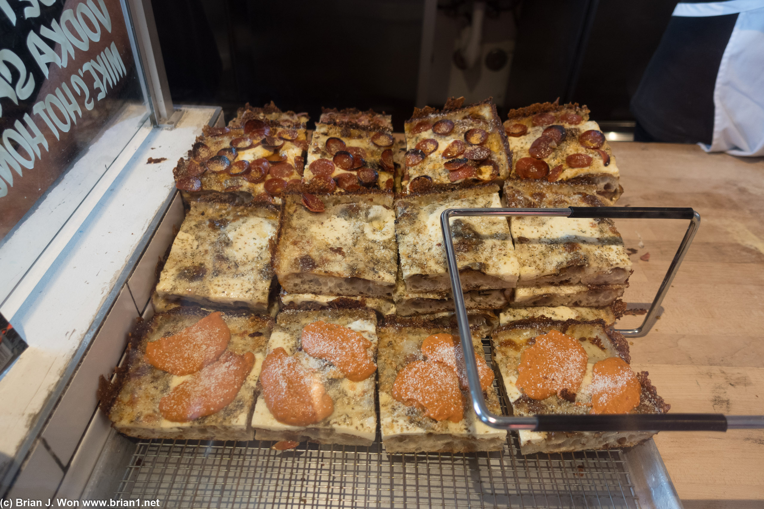 Stacks of Sicilian pizza slices.