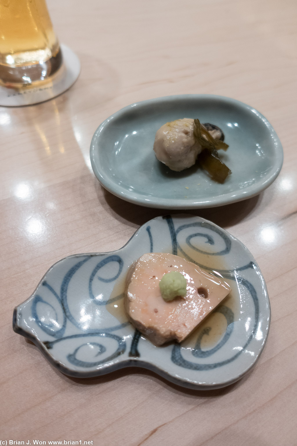 Ankimo (monkfish liver) with wasabi at front, oyster with seaweed at rear.