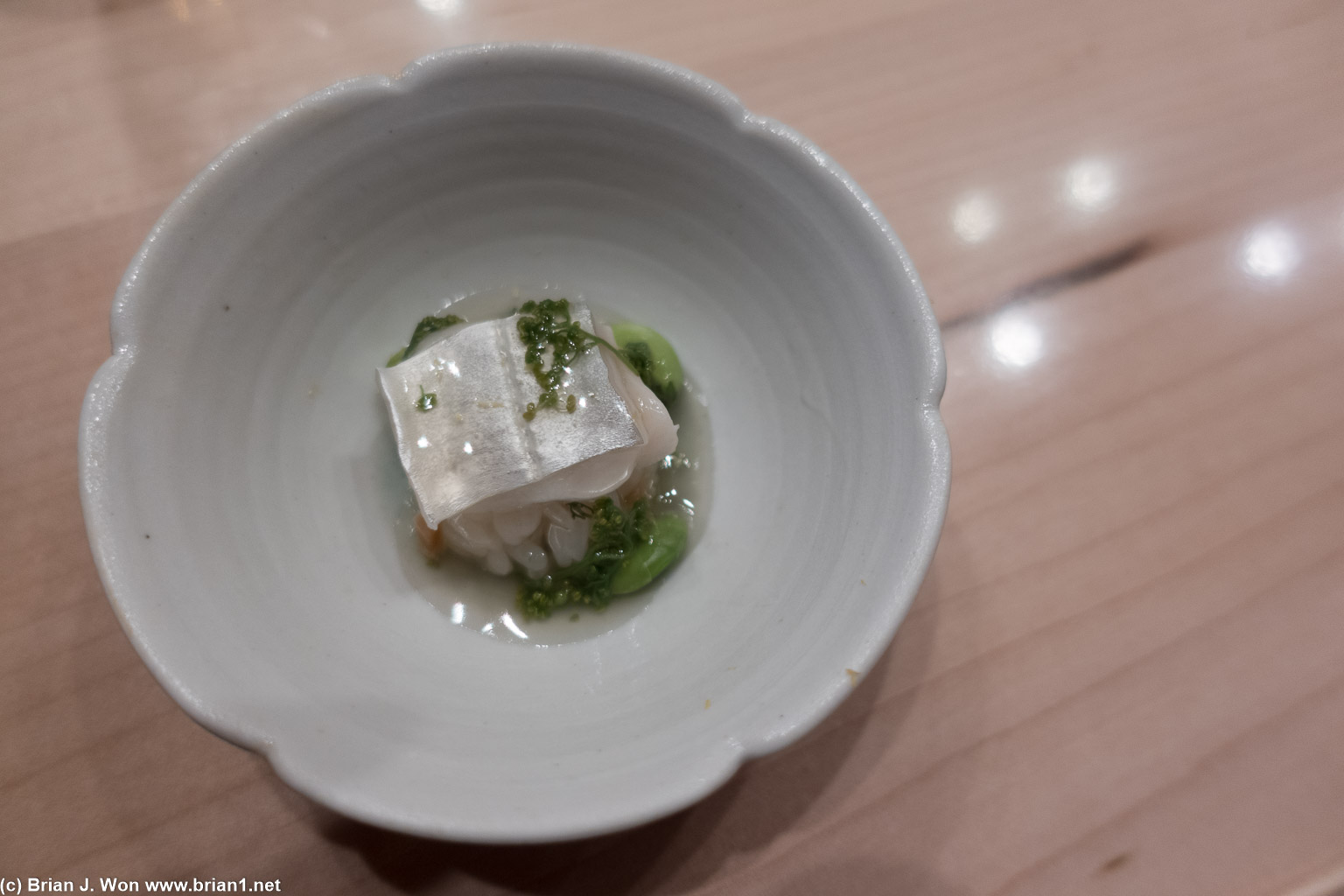 Steamed tachiuo (beltfish) with daishi sauce and sanshao flower.