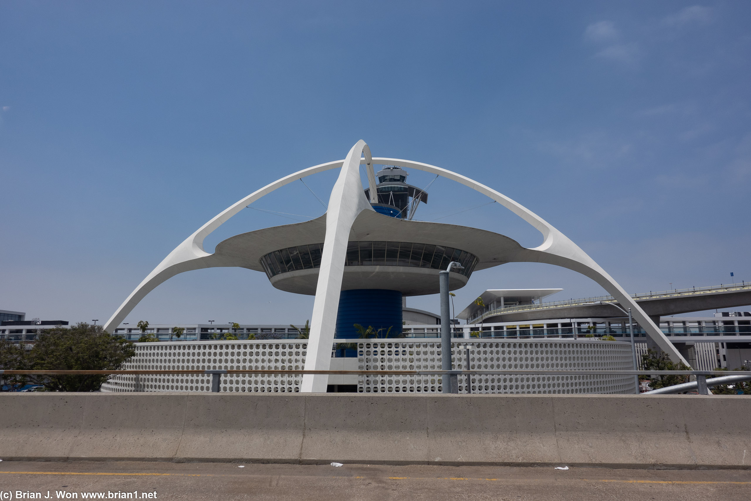 LAX theme building with the automated people mover track curved around to the right.