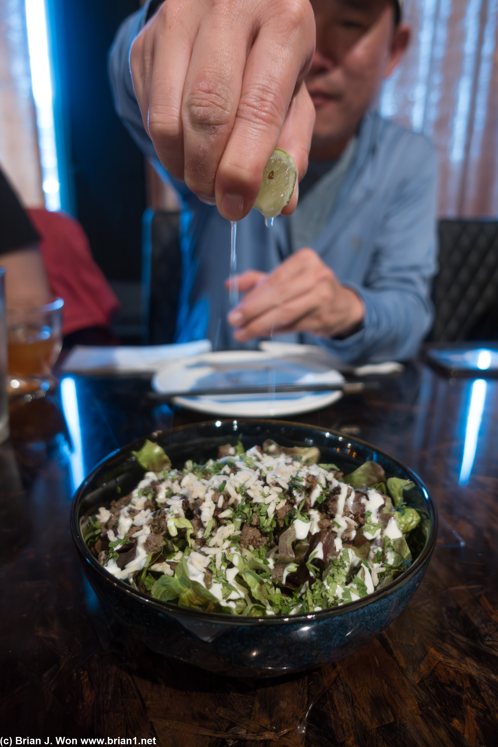 Mike squeezes lime onto the beef salad.