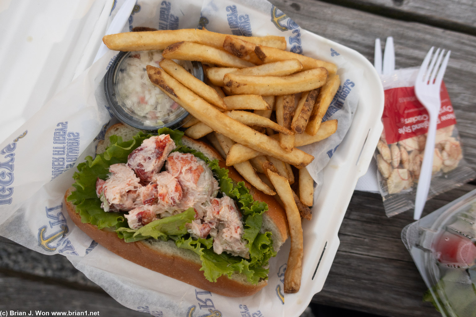 Lobster roll, fries, and coleslaw.