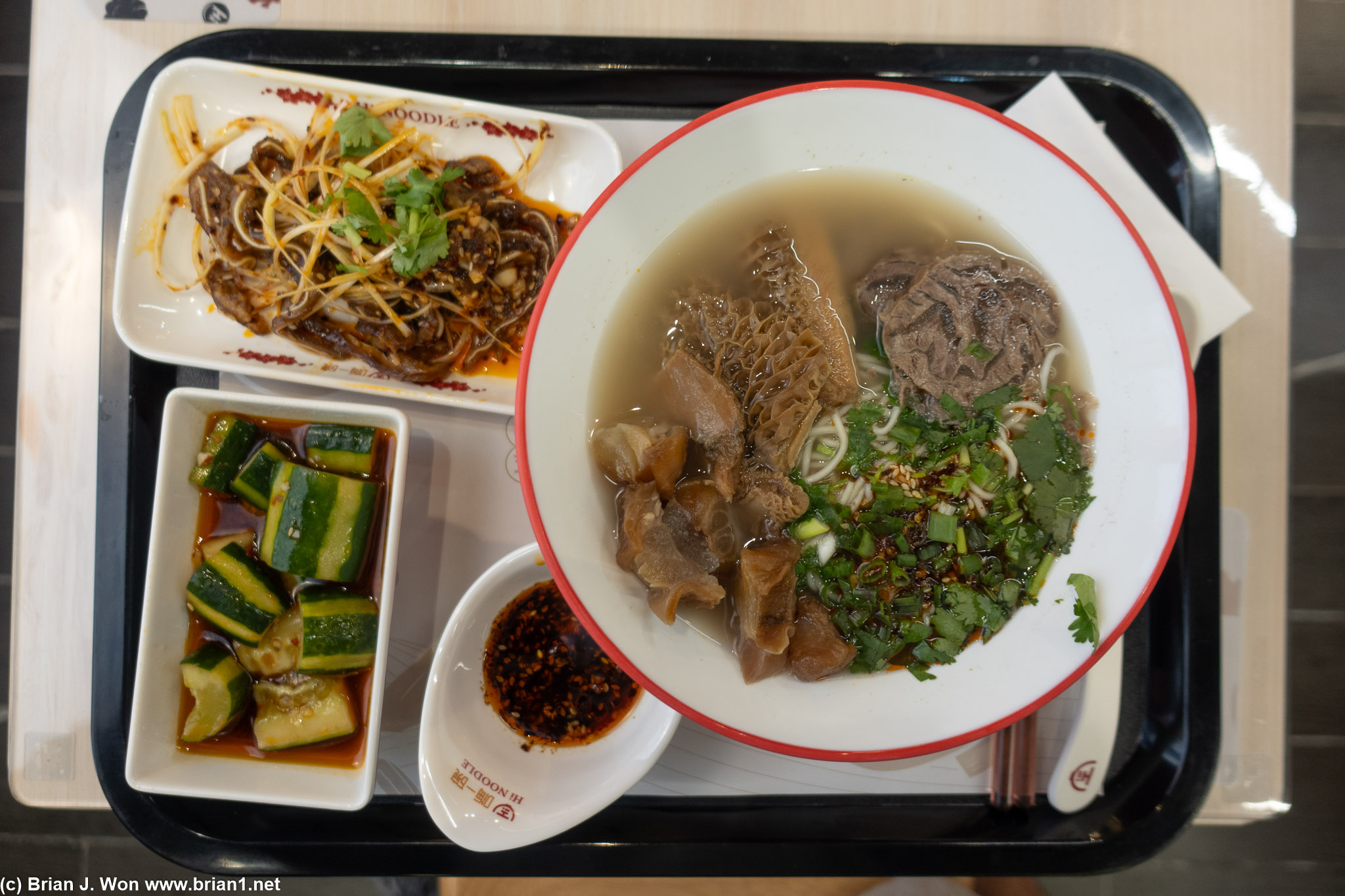 Spicy mixed beef noodle with side of pig ear and side of cold cucumber.