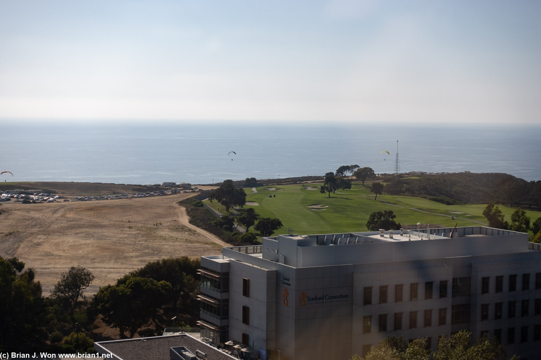 Paragliders in the distance.