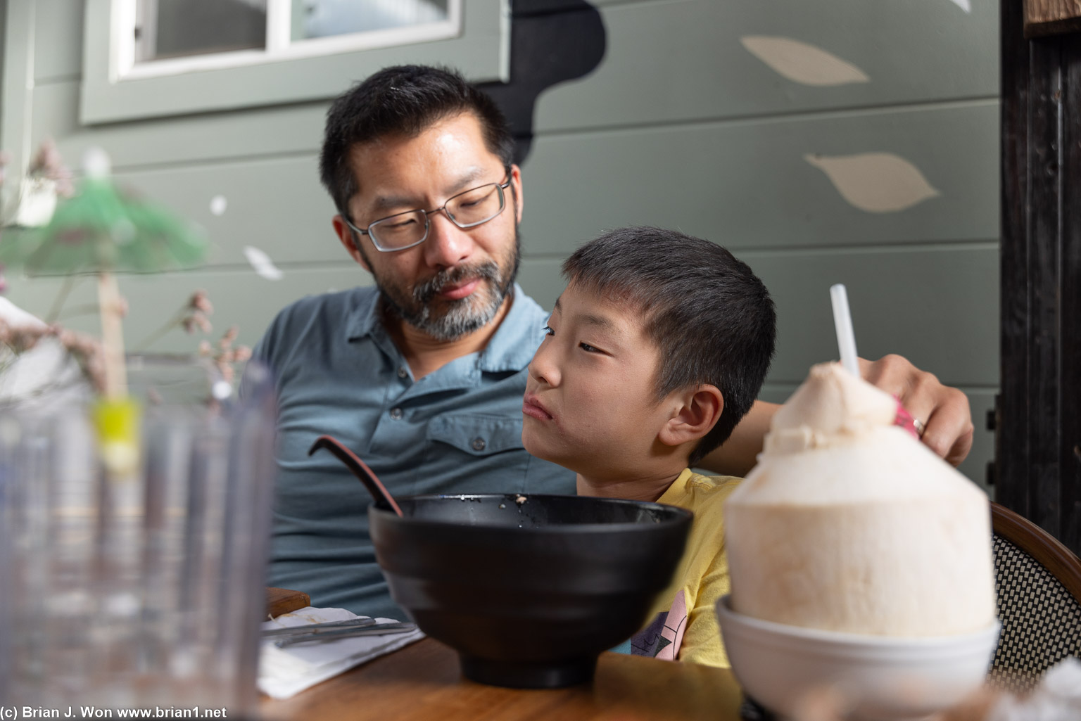 Defiant expression under his dad's penetrating gaze.