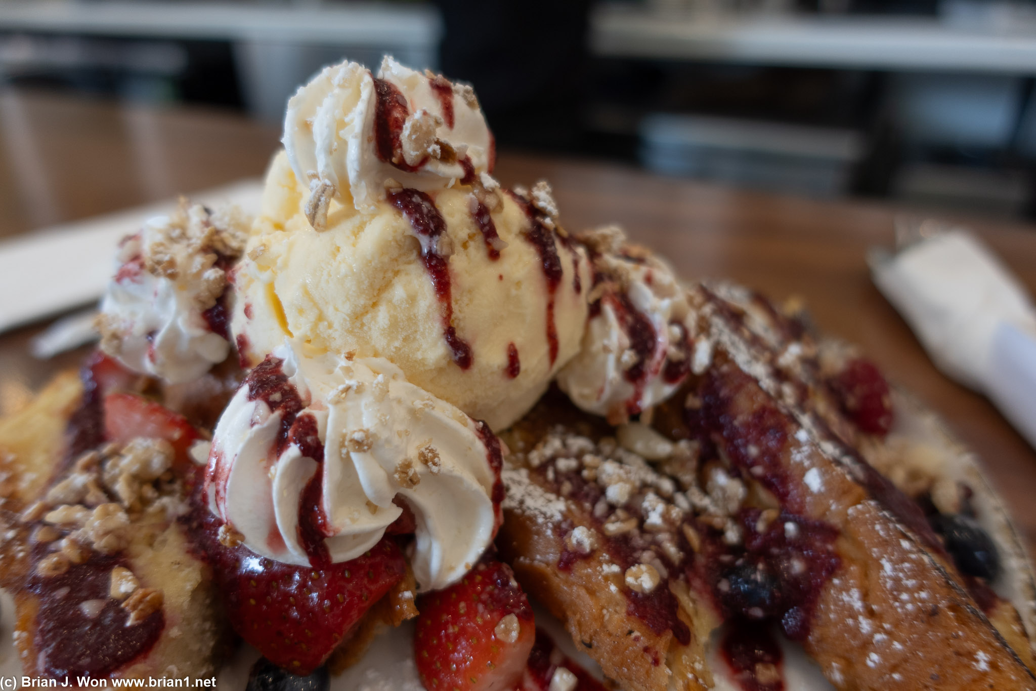 Flaky french toast with berry topping and ice cream.