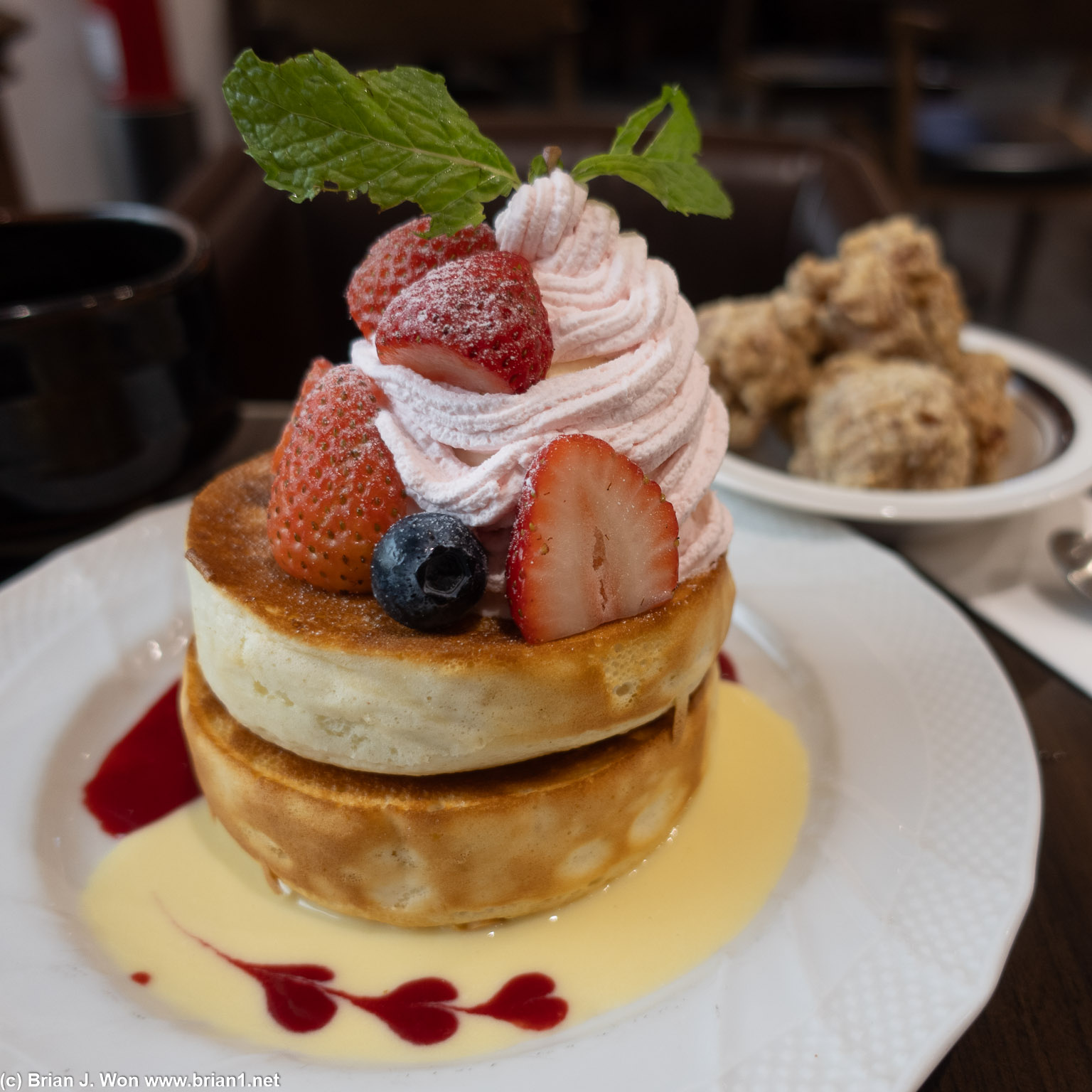 Souffle pancakes with fruit, ice cream, whipped cream.