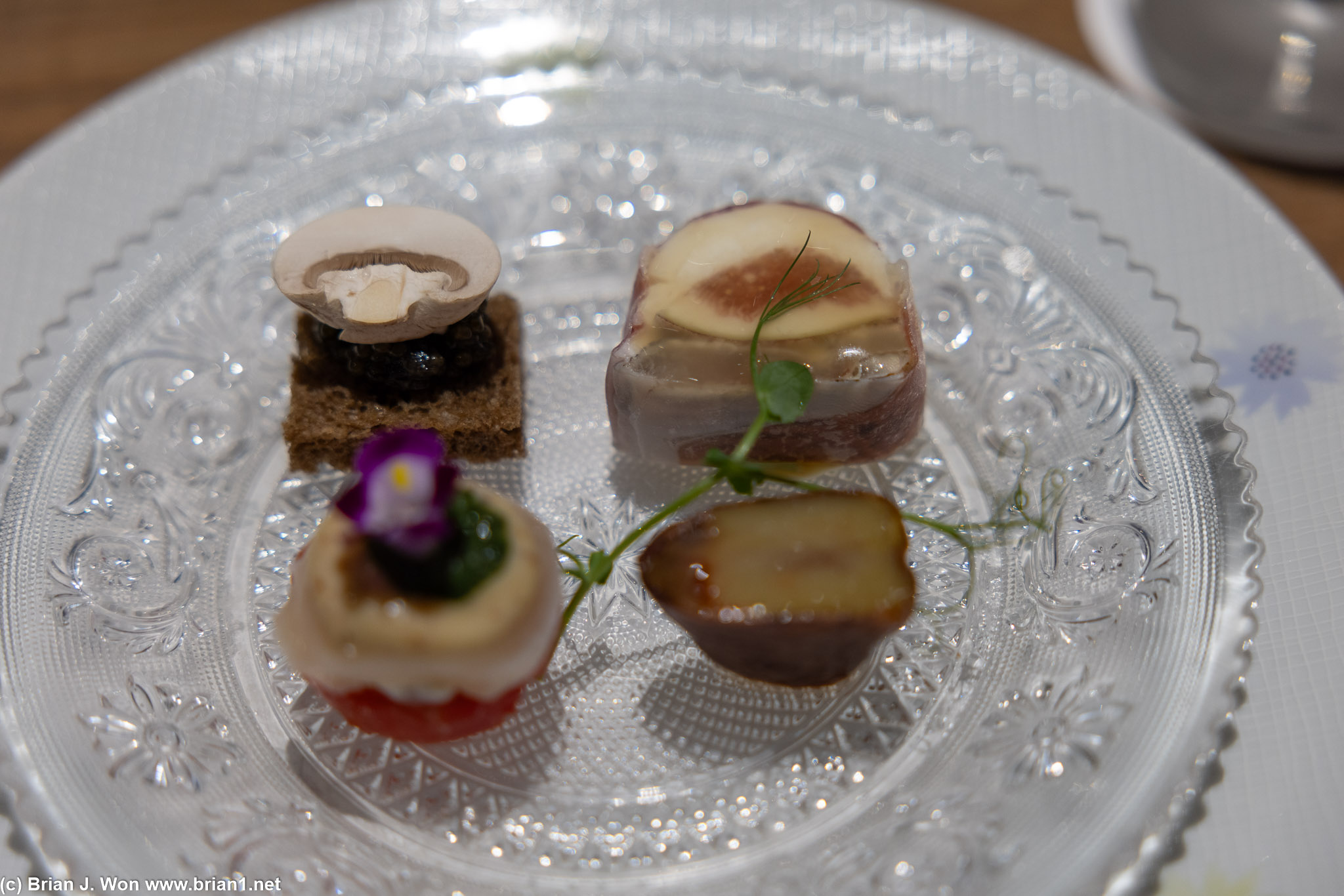 Appetizers, including fig, mushroom, tomato, chestnut, and caviar.