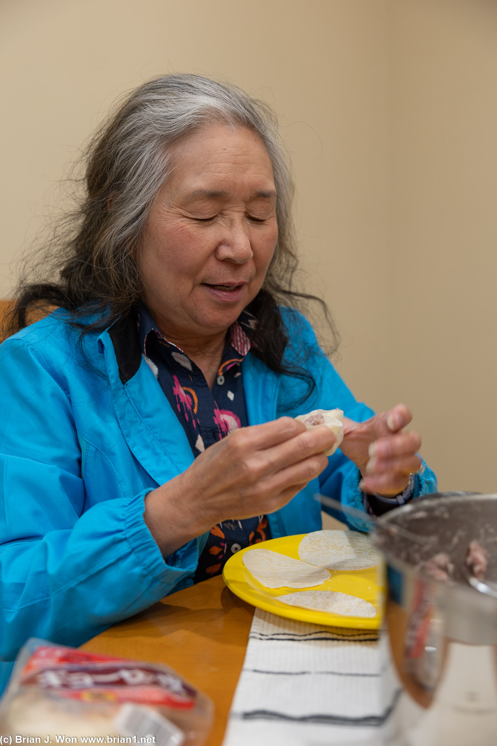 Mom giving siu mai making lessons.